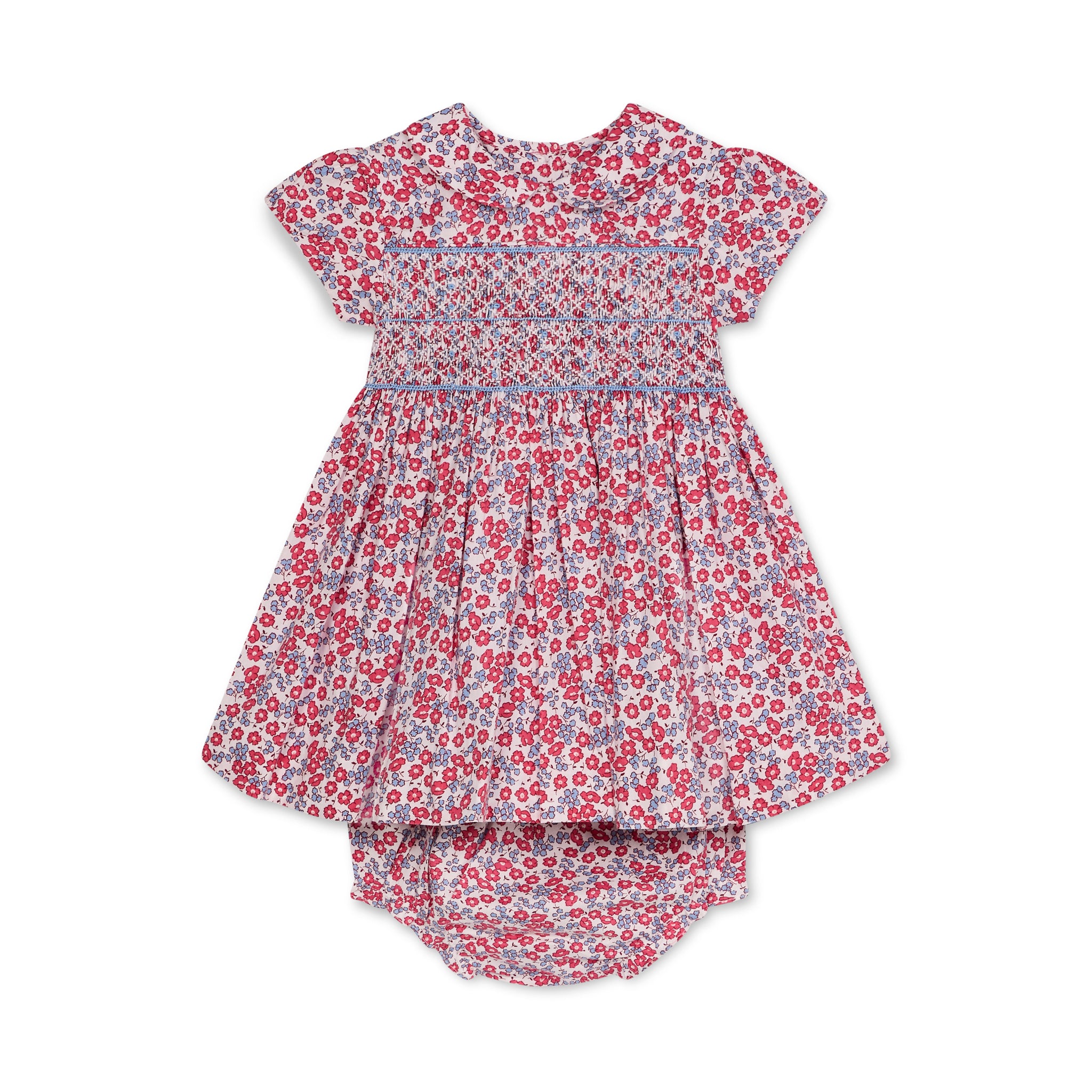 Floral baby smock dress and bloomers set on a white background