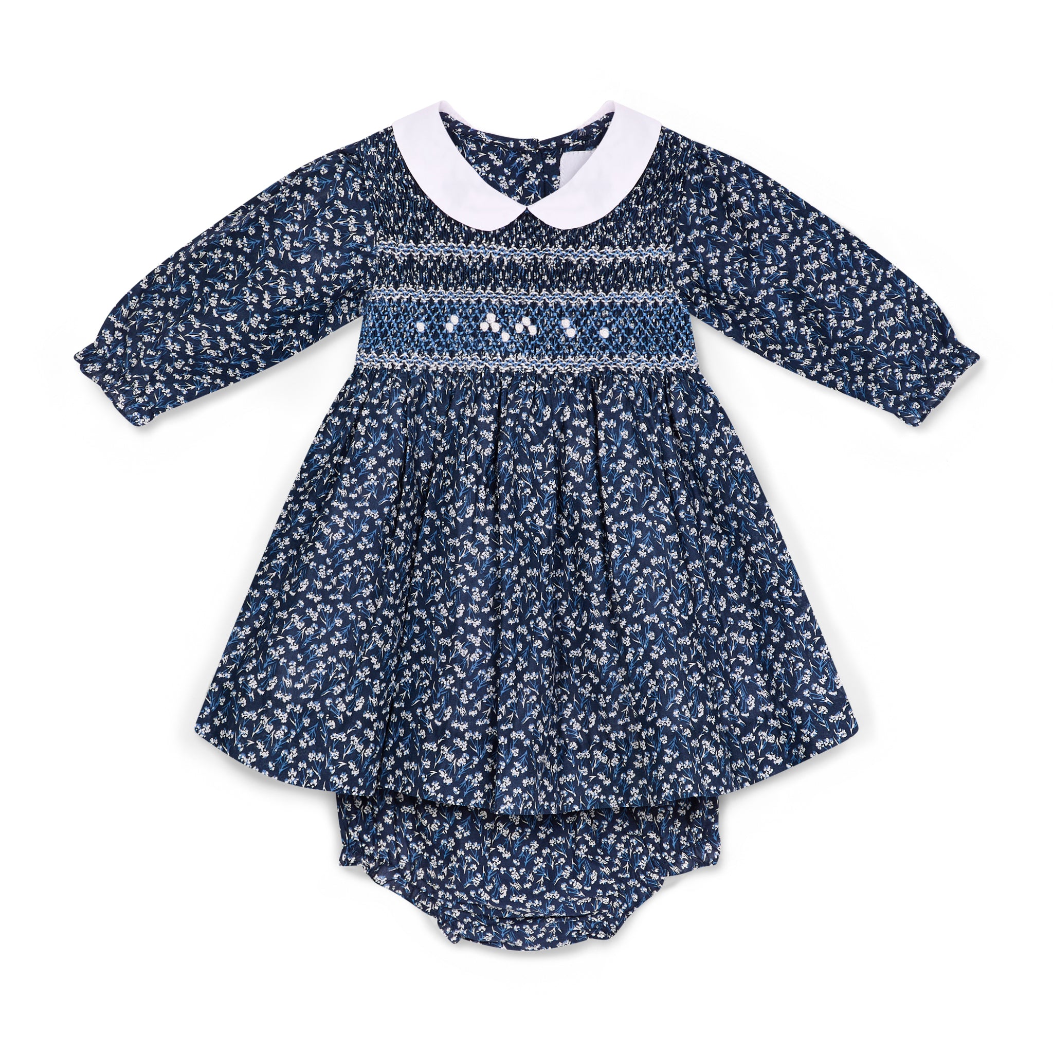 Navy floral baby dress with matching bloomers and a white Peter Pan collar on a white background