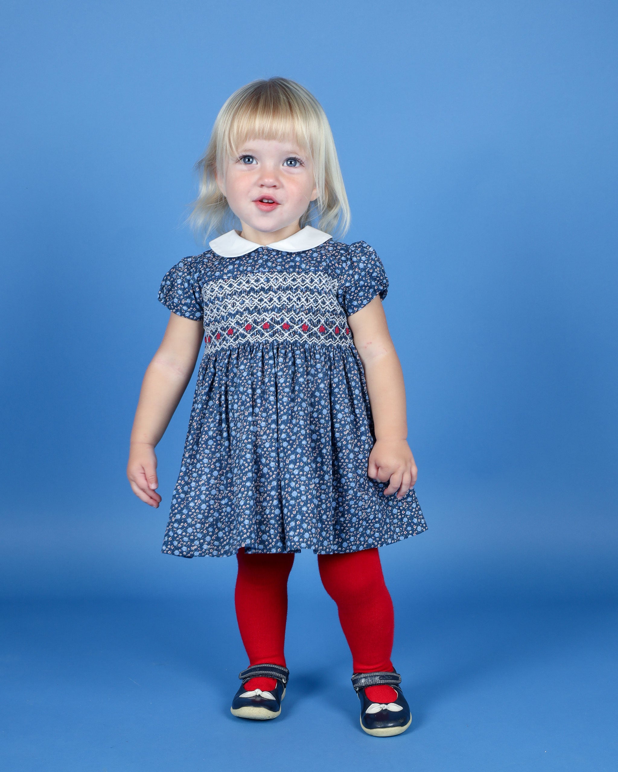 toddler girl in hand-smocked dress, floral, navy blue