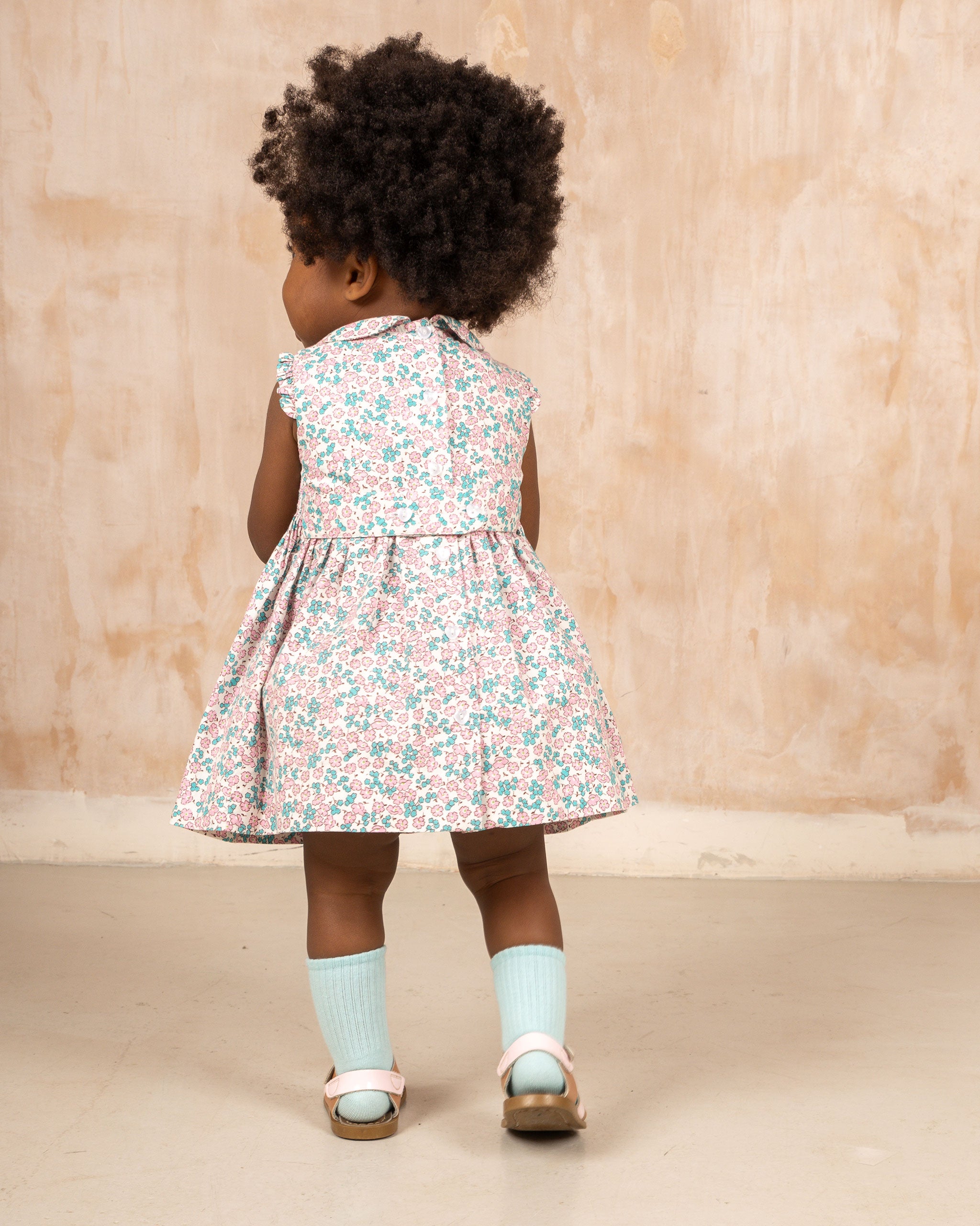 baby in smocked dress, back