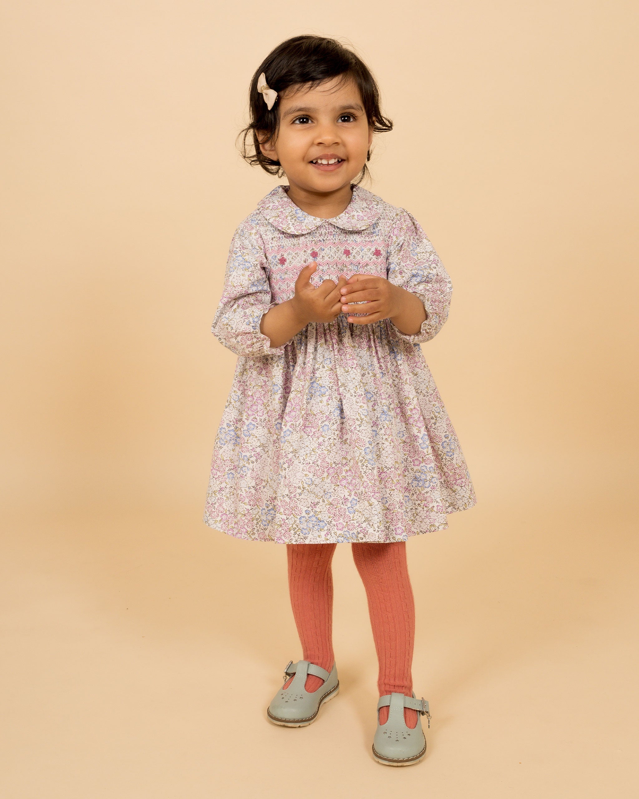 toddler wearing floral, hand-smocked dress