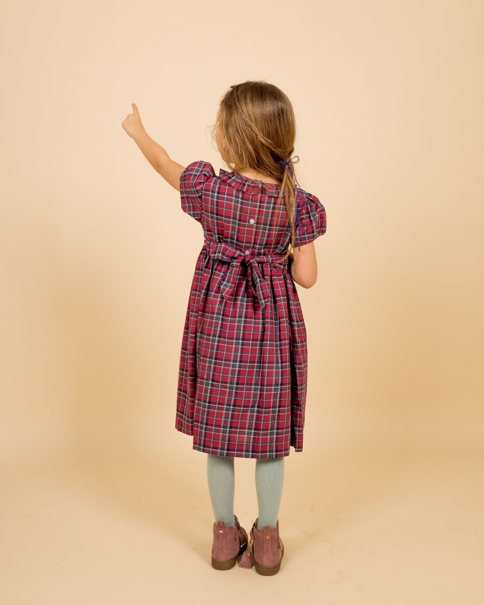 girl wearing tartan dress, back