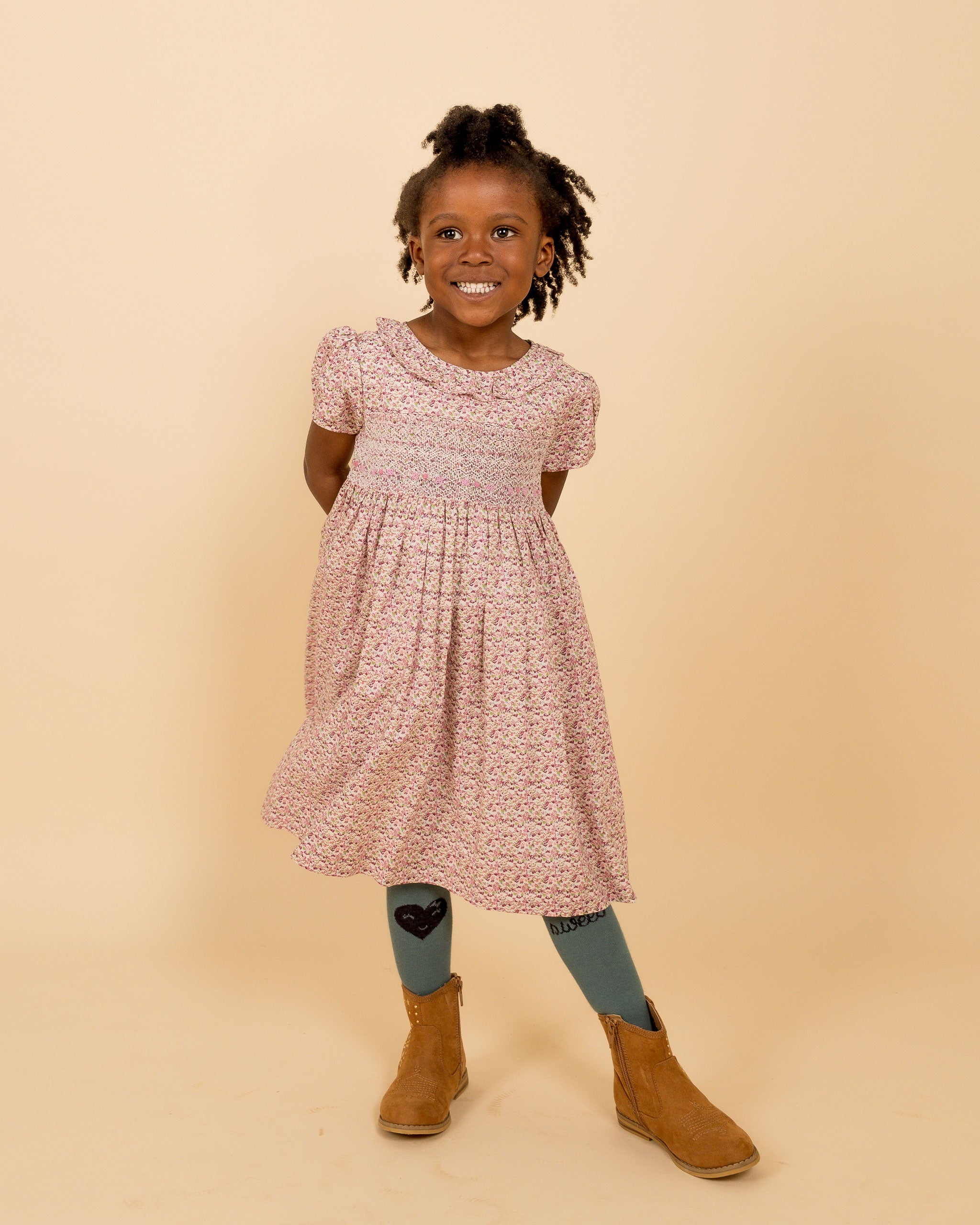 girl wearing ditzy floral smock dress in autumn colours