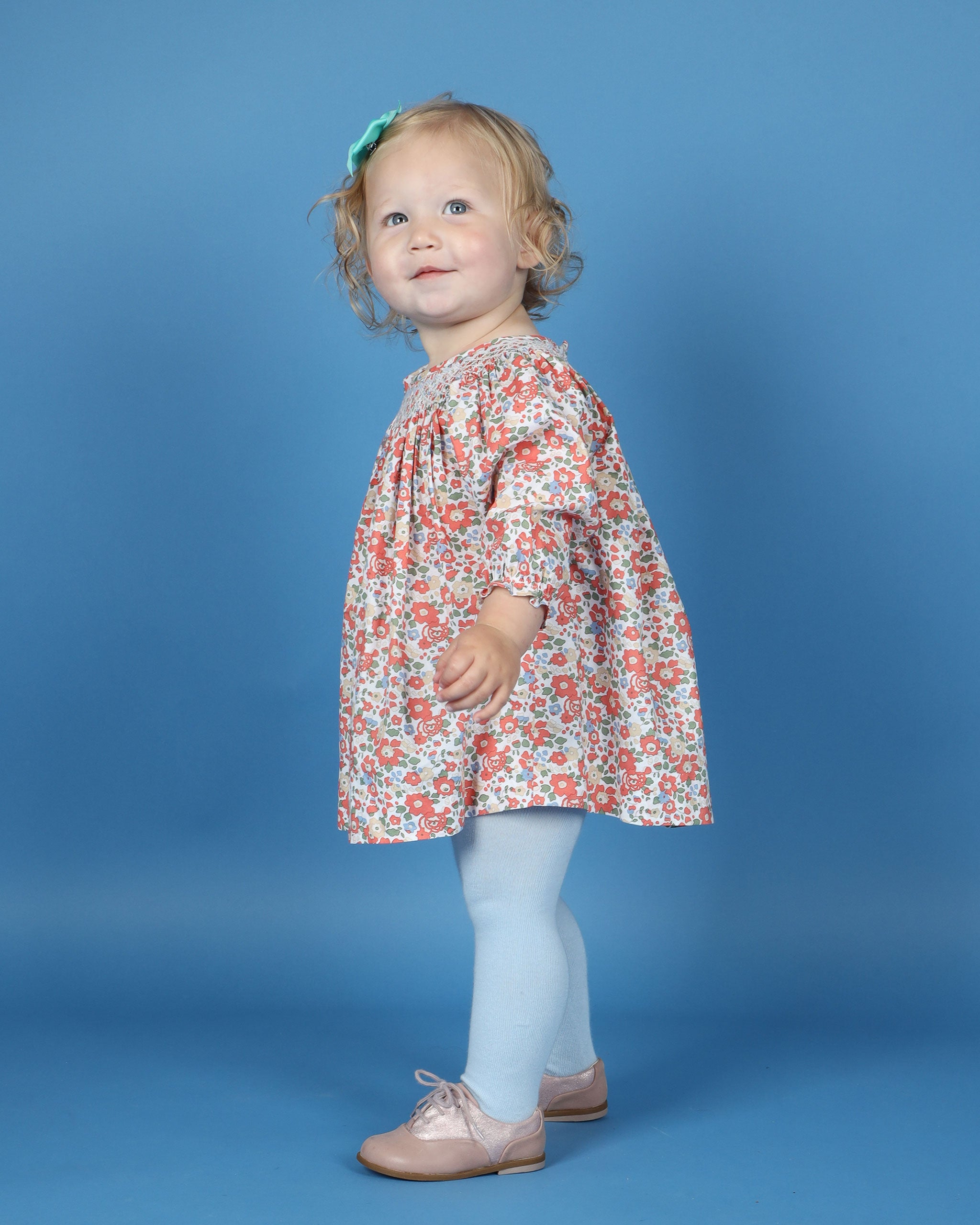 baby girl in floral smock dress