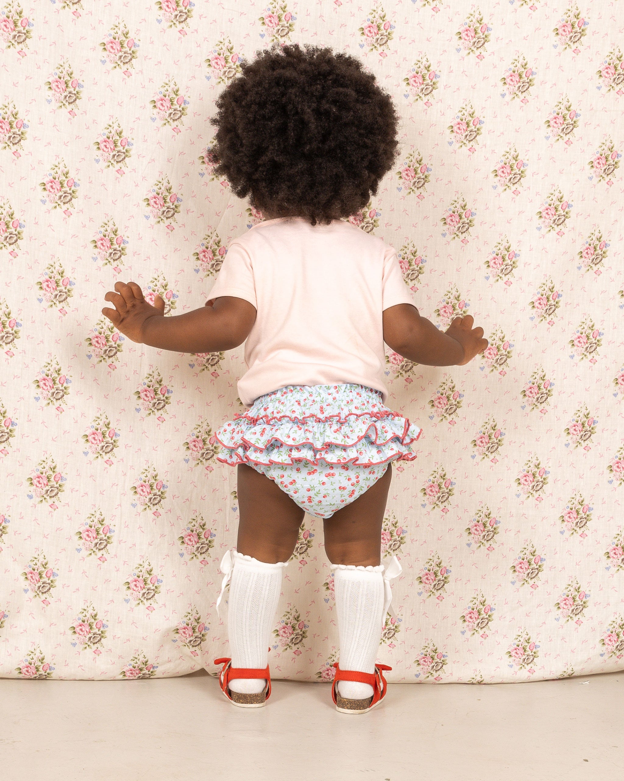 baby in ruffle shorts, blue