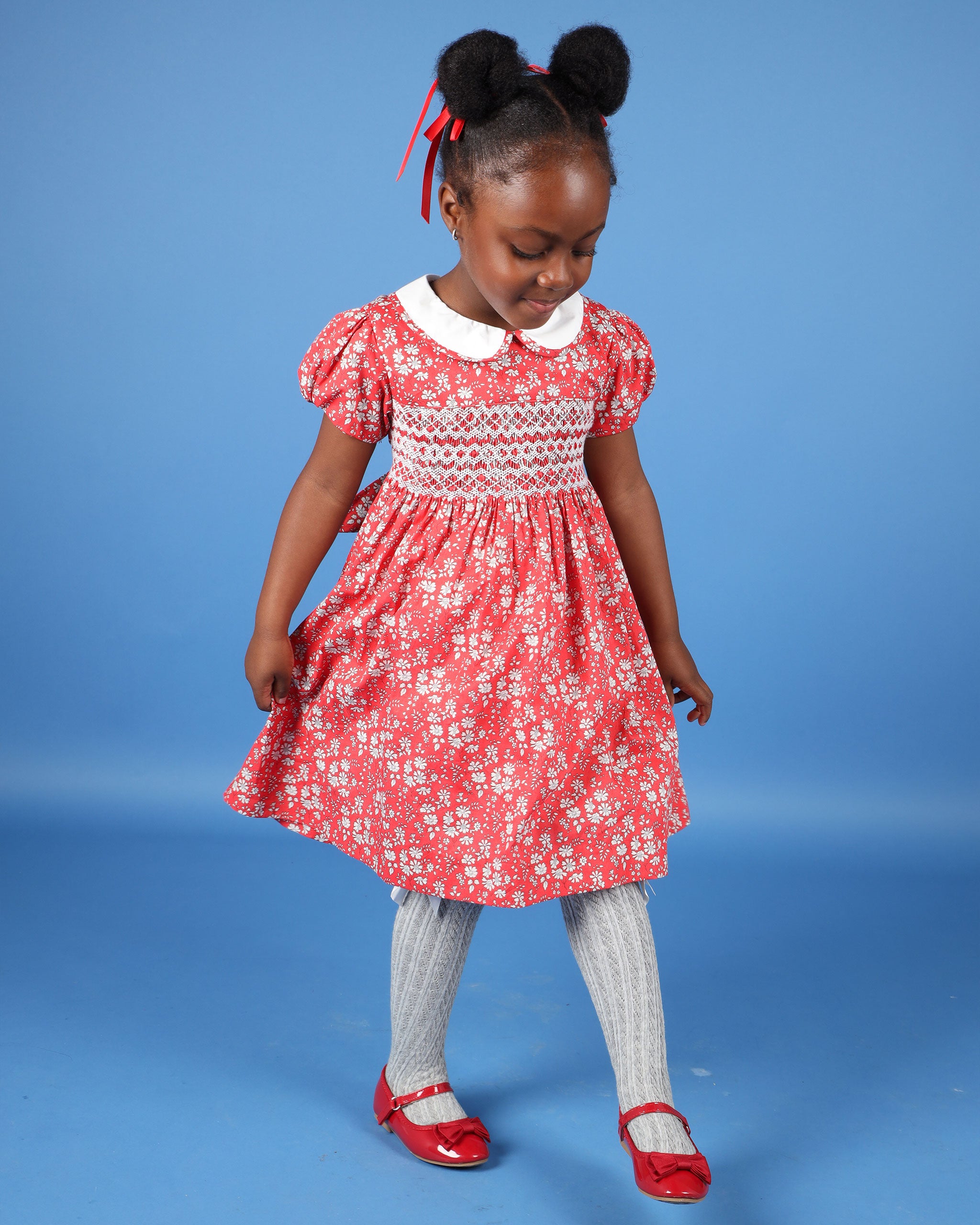girl in red and white floral dress made form Liberty Fabric, hand-smocked