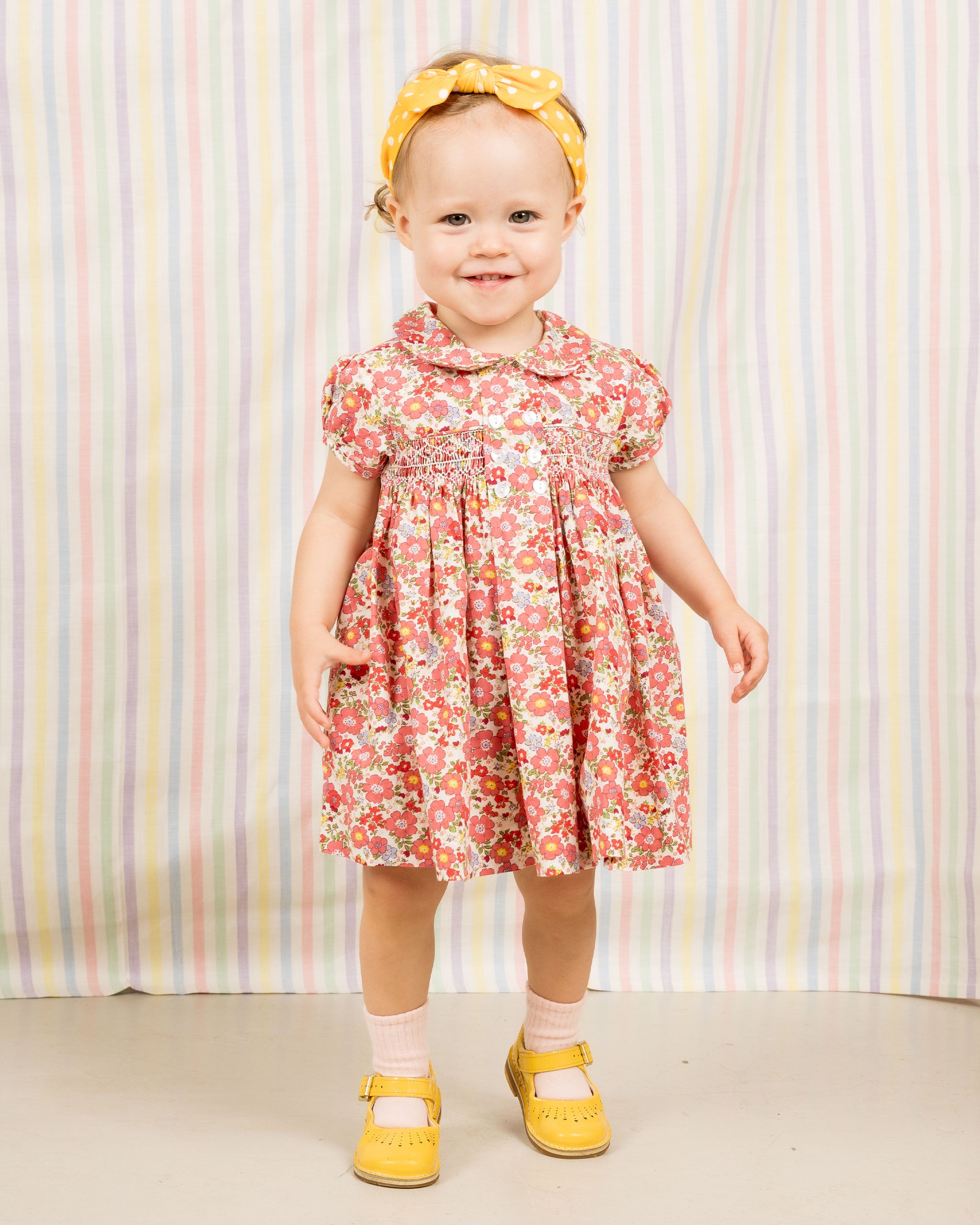 toddler girl in red floral smock dress