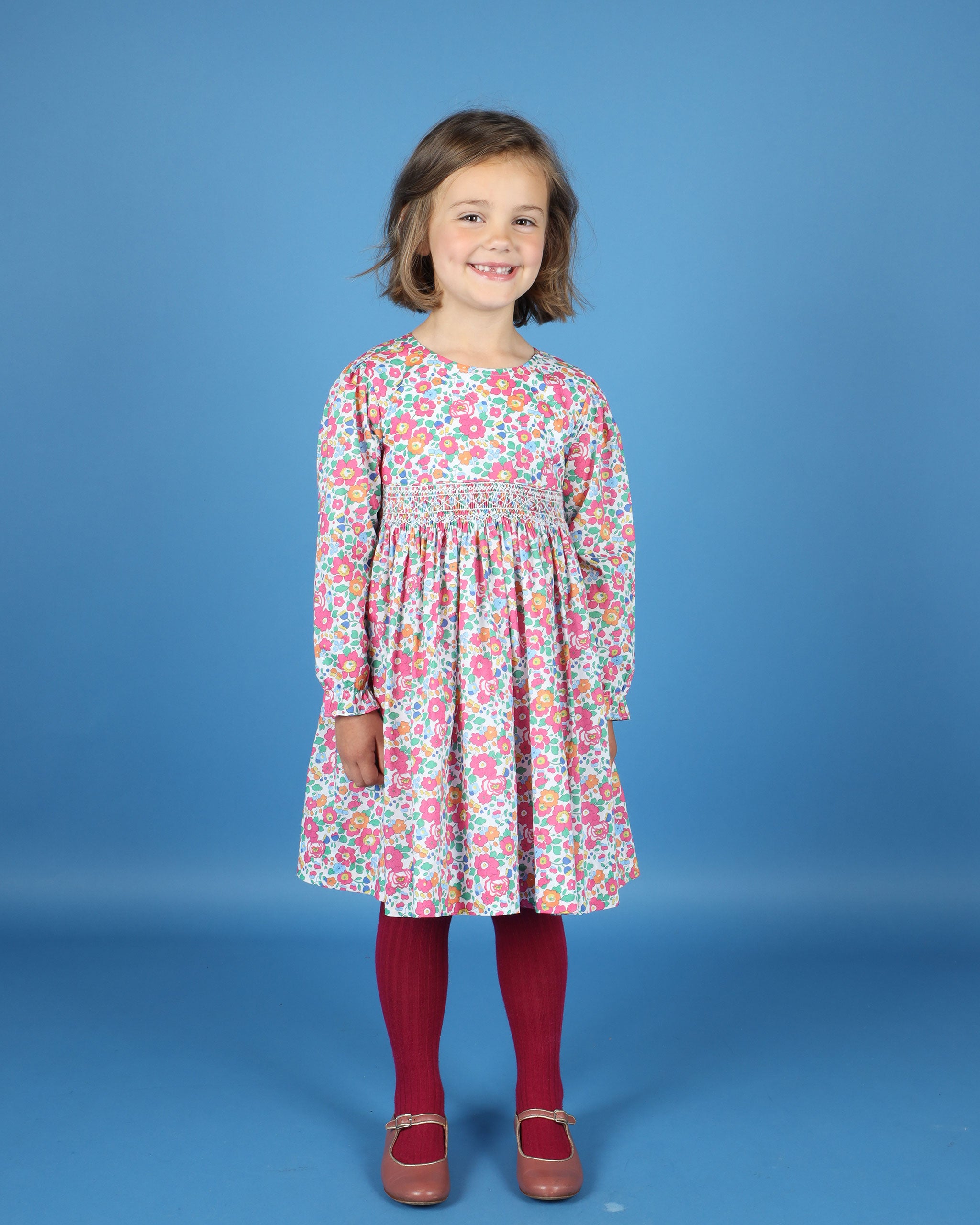 girl in hand-smocked Liberty fabric dress, floral design
