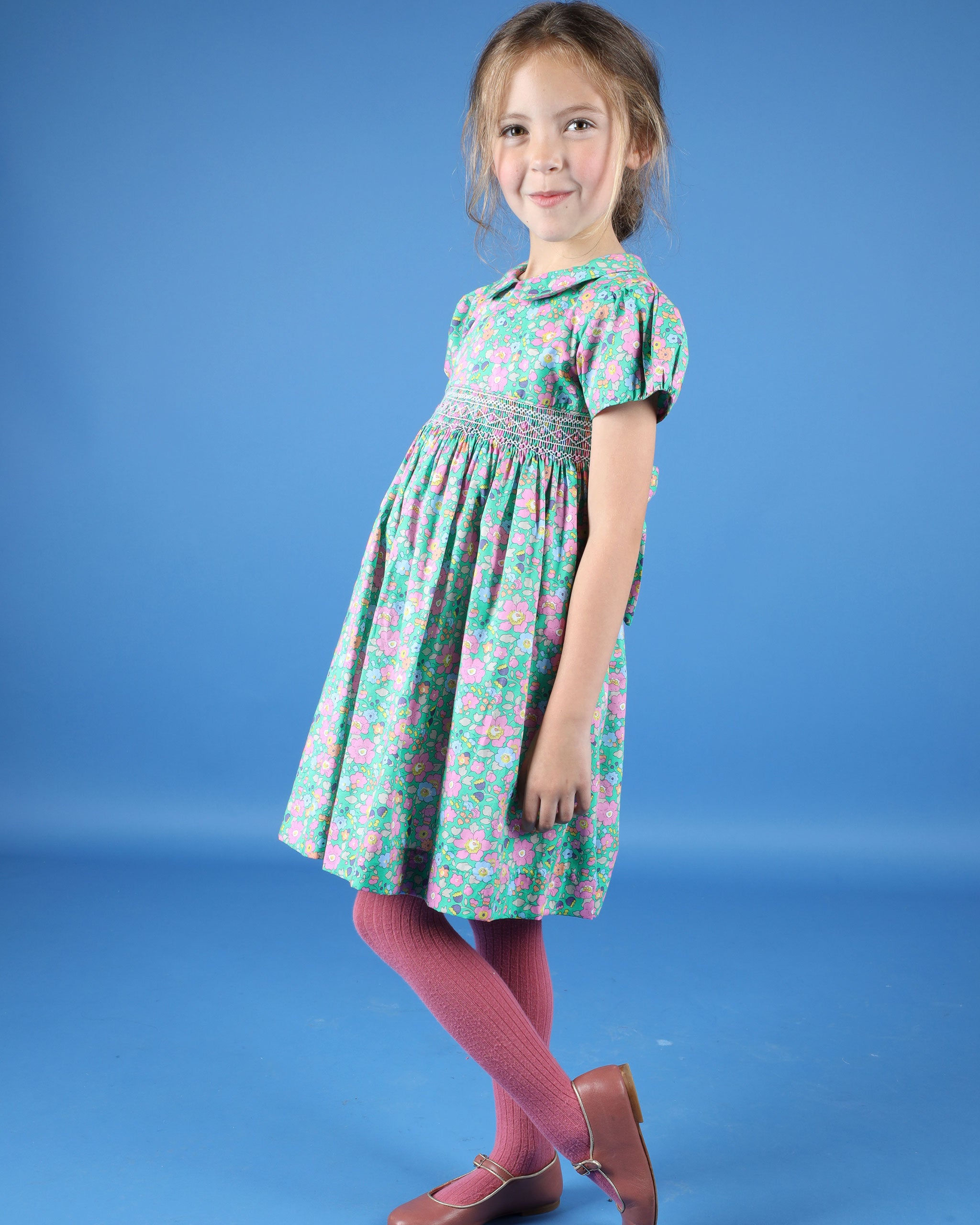 girl in green floral dress made from Liberty fabric, hand-smocked design