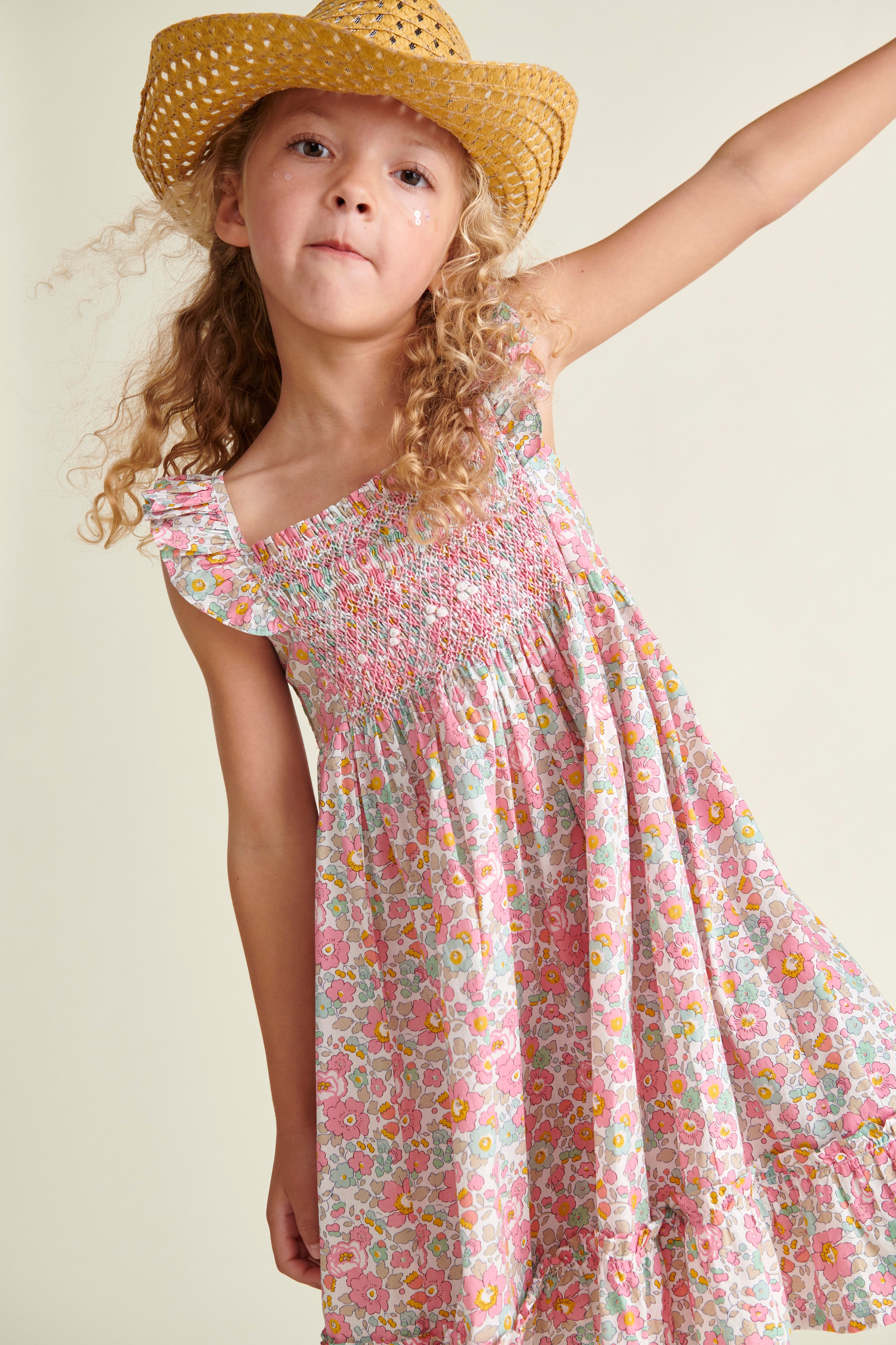 girl in smocked sun dress, made from Liberty fabric, close up