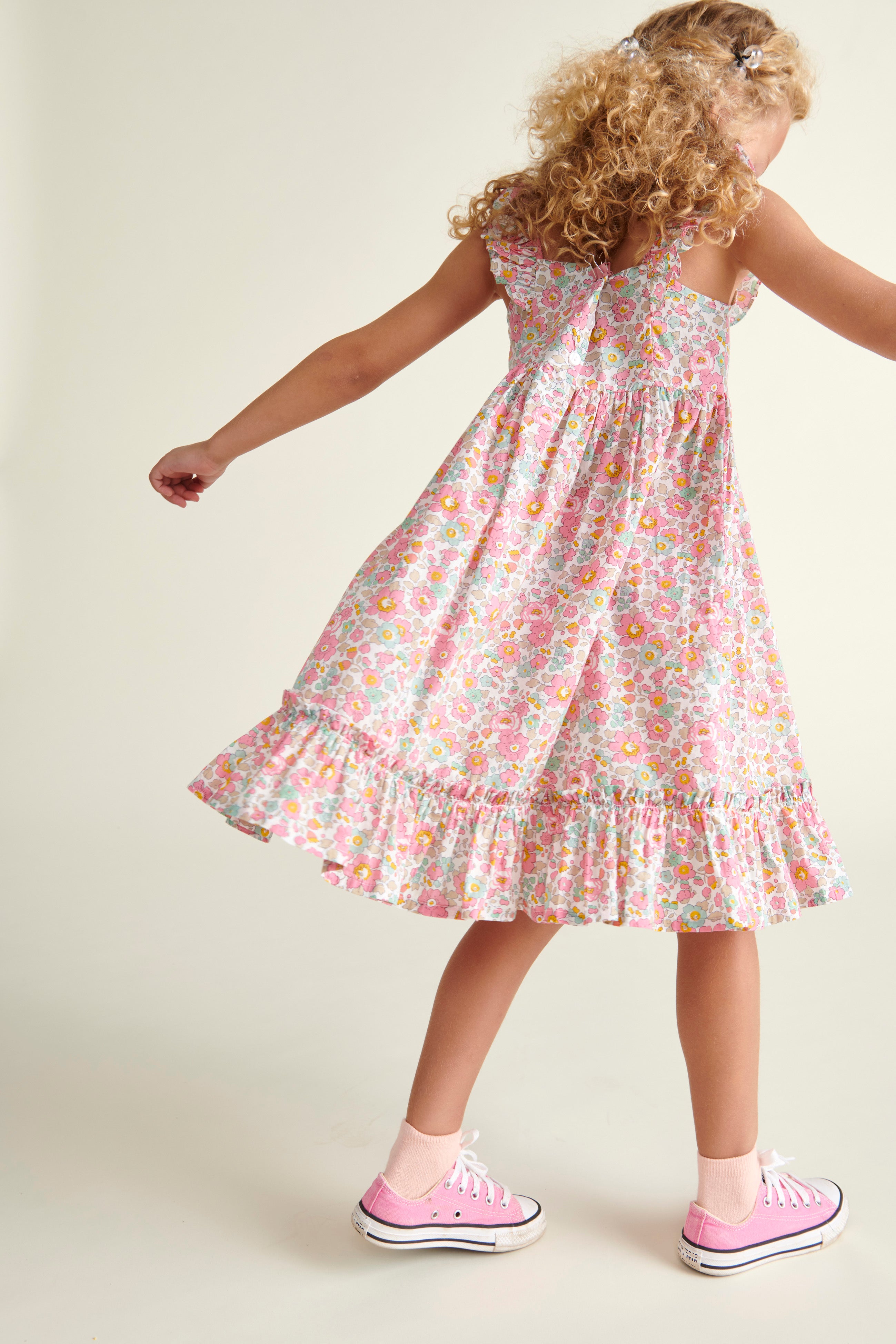 girl in smocked sun dress, made from Liberty fabric, back view