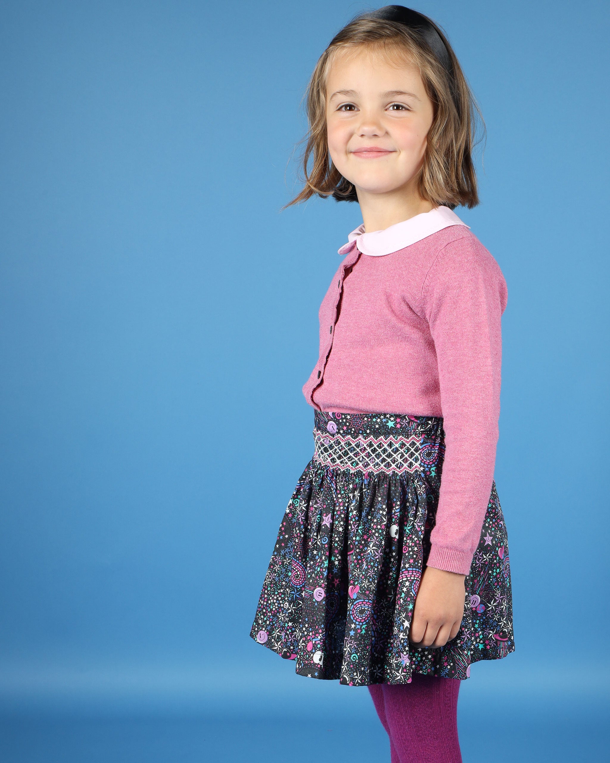 Girl in star print smocked skirt, Liberty fabric