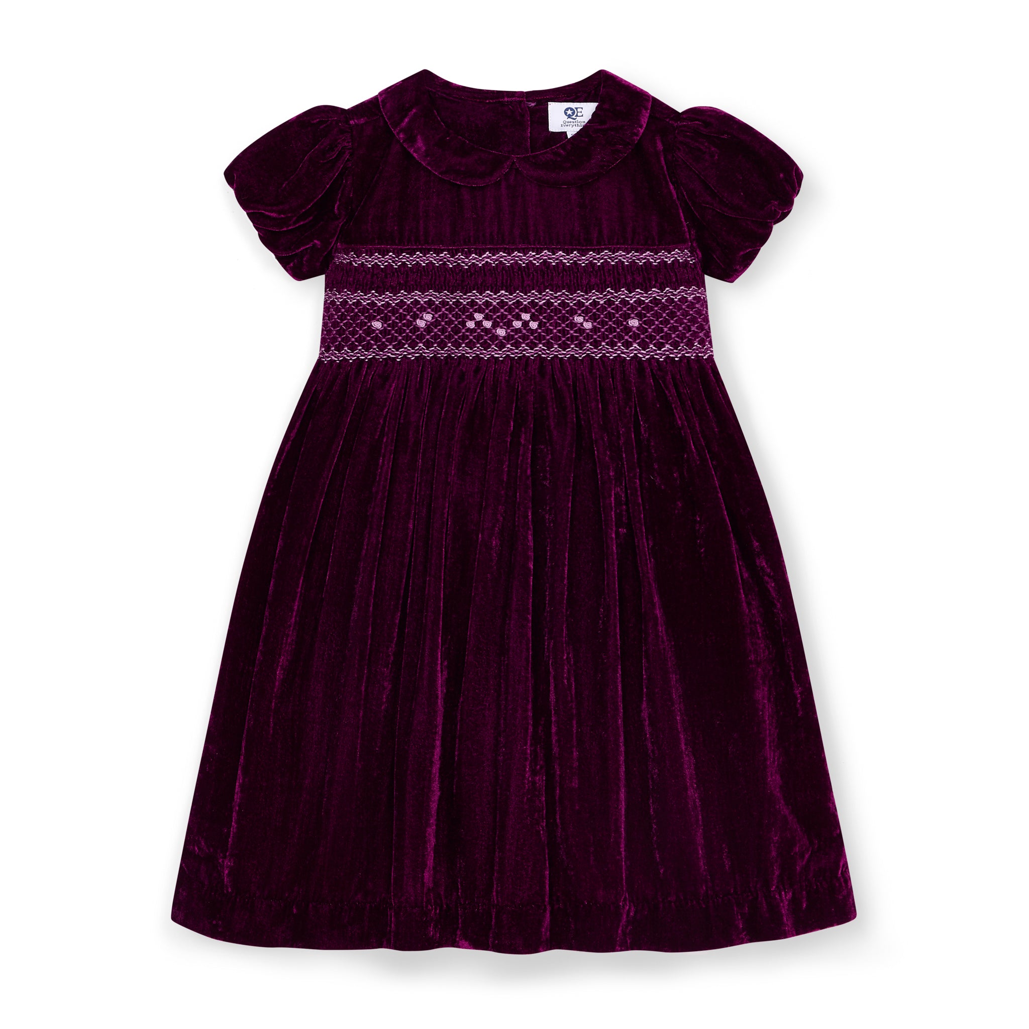Burgundy velvet dress with embroidered details on intricate hand-smocking