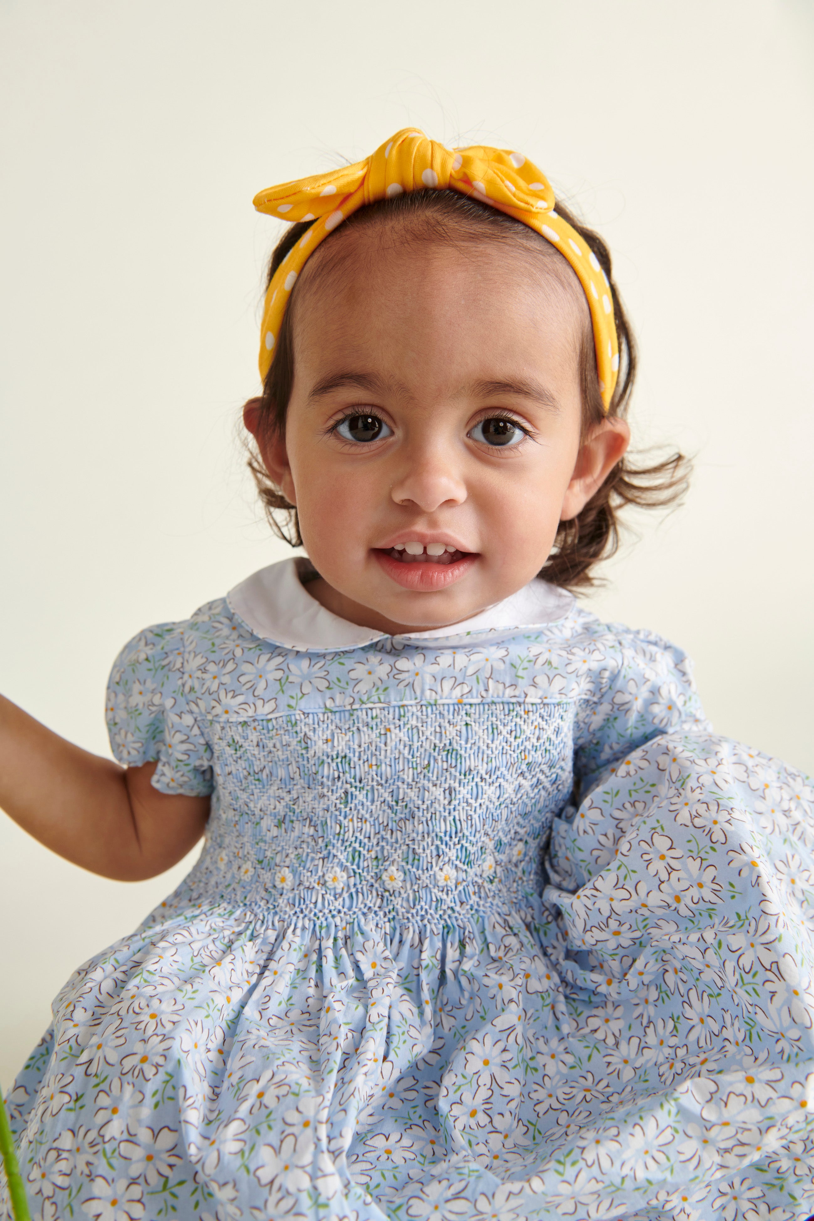 baby girl in pale blue smocked dress