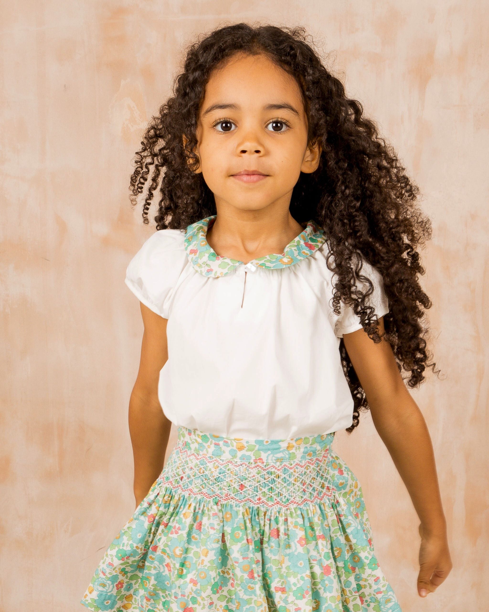 girl wearing blouse and skirt set, made from Liberty fabric