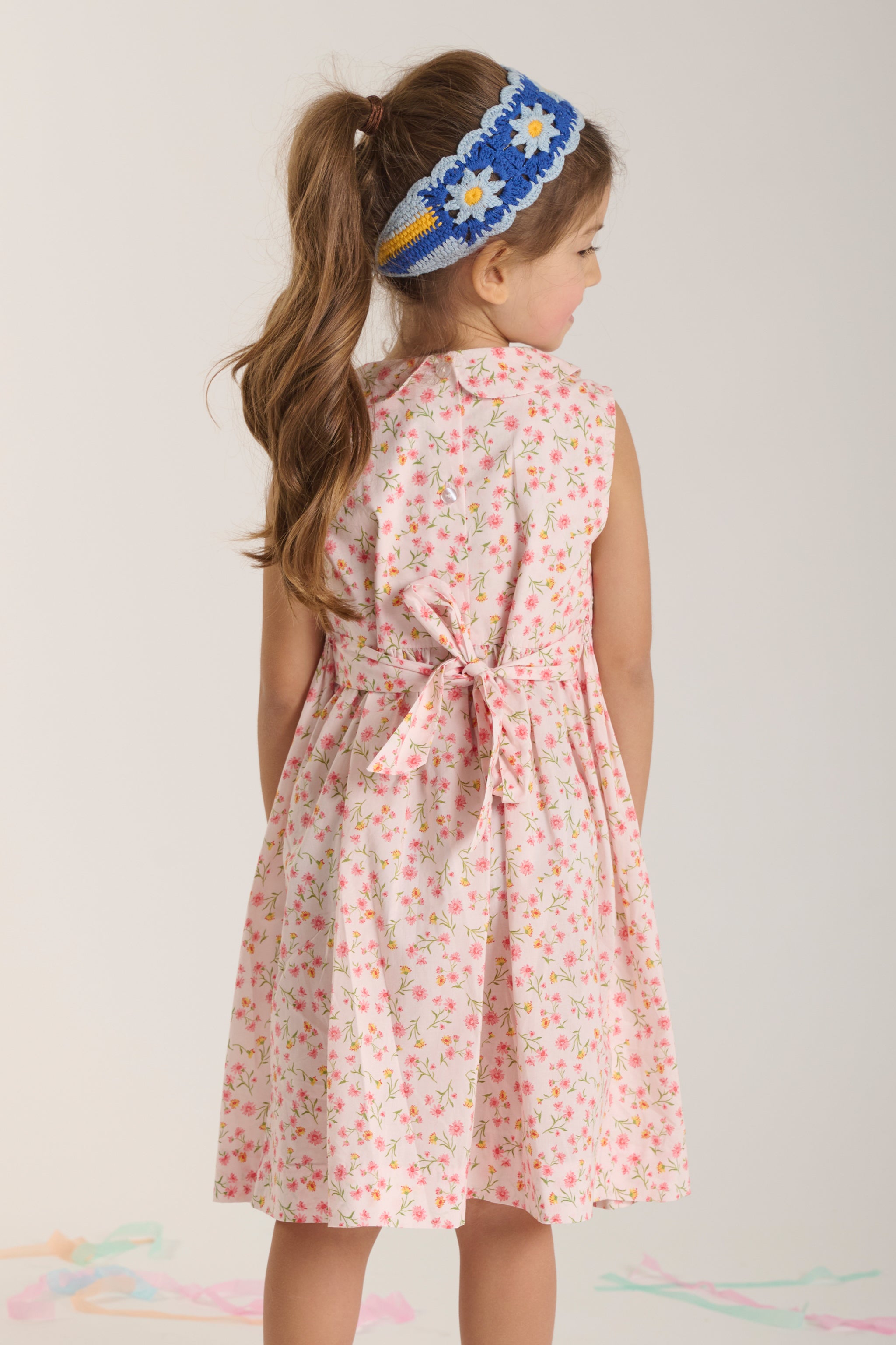 girl in daisy print dress back