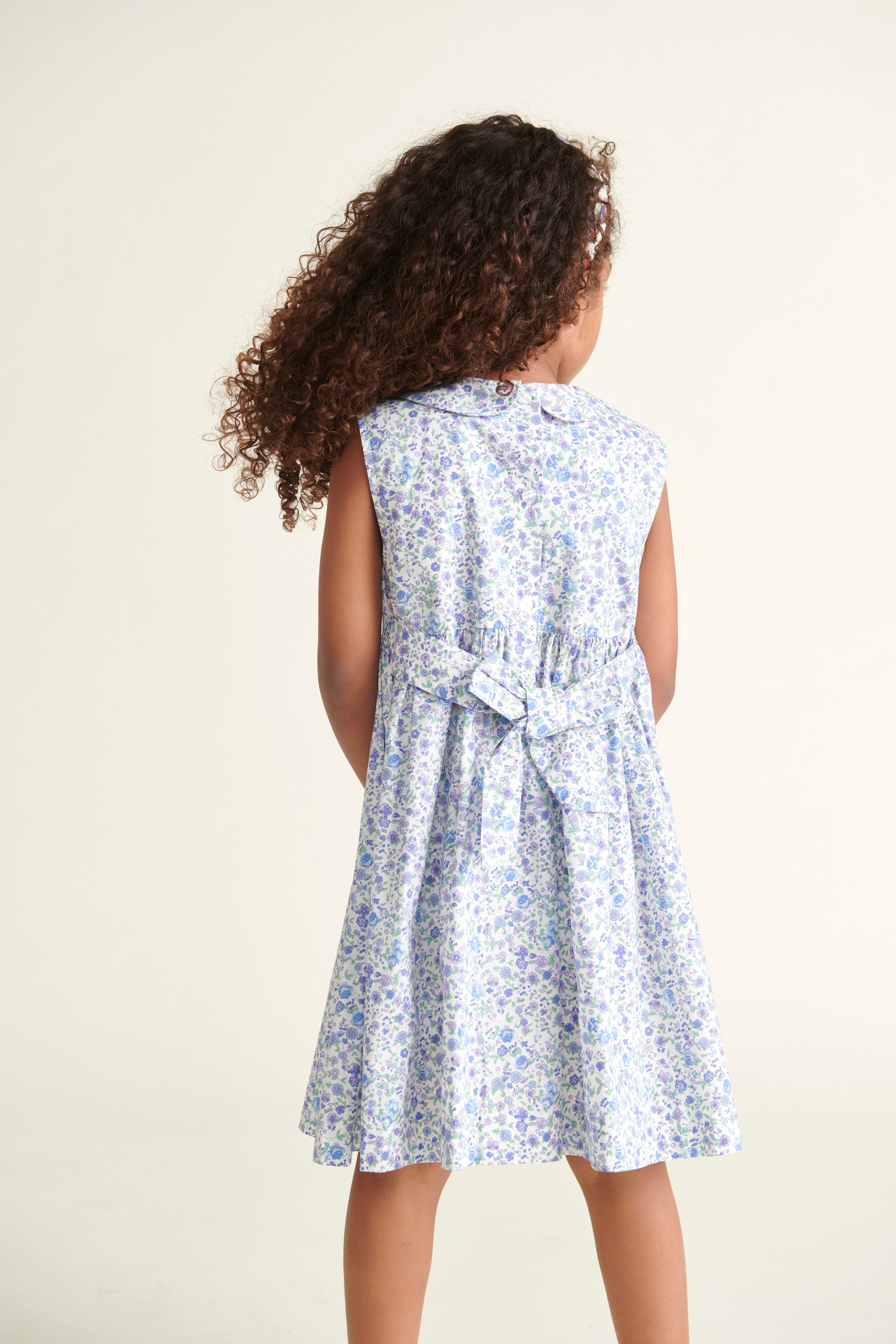 girl in smocked dress, back