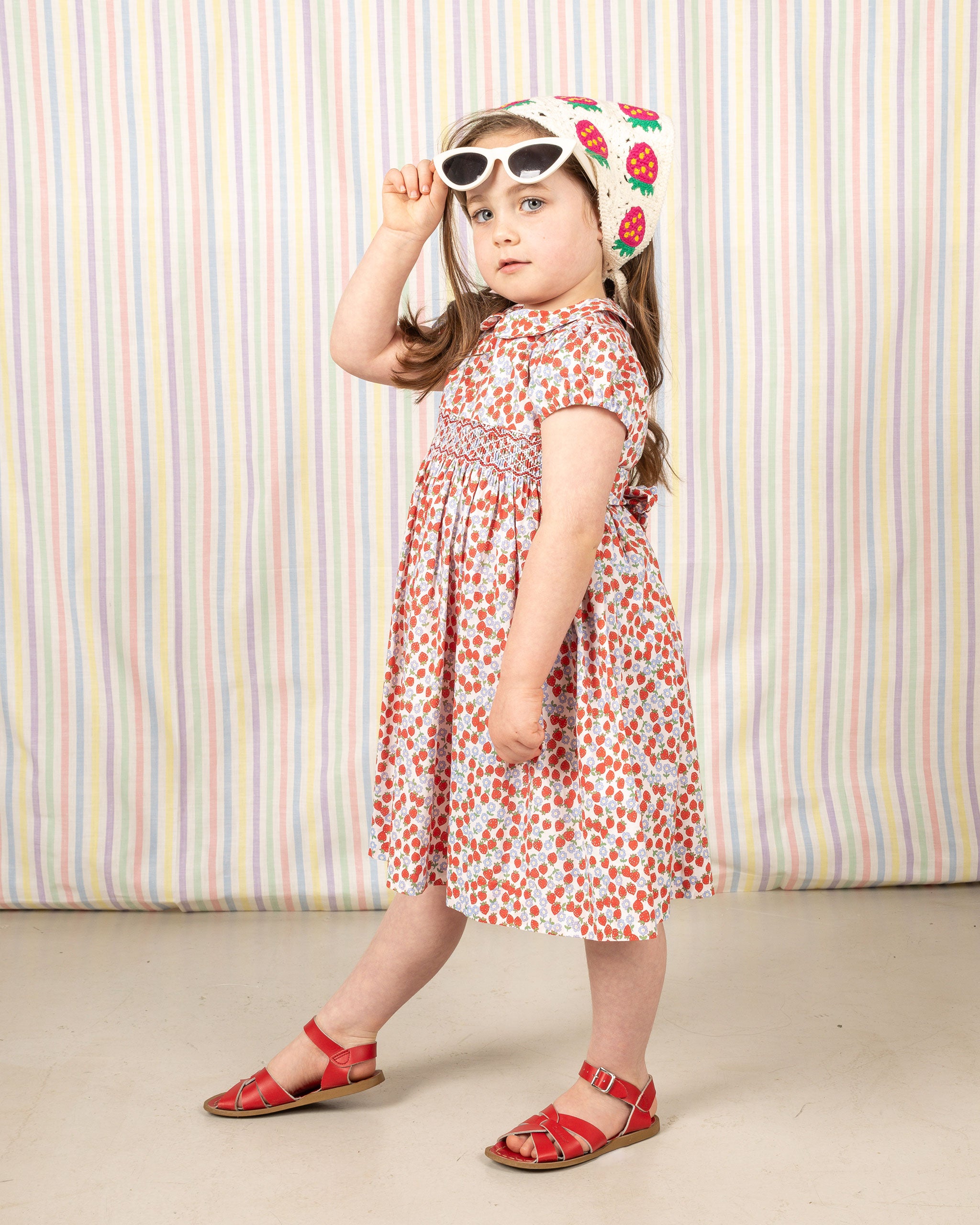 girl in smocked strawberry print dress