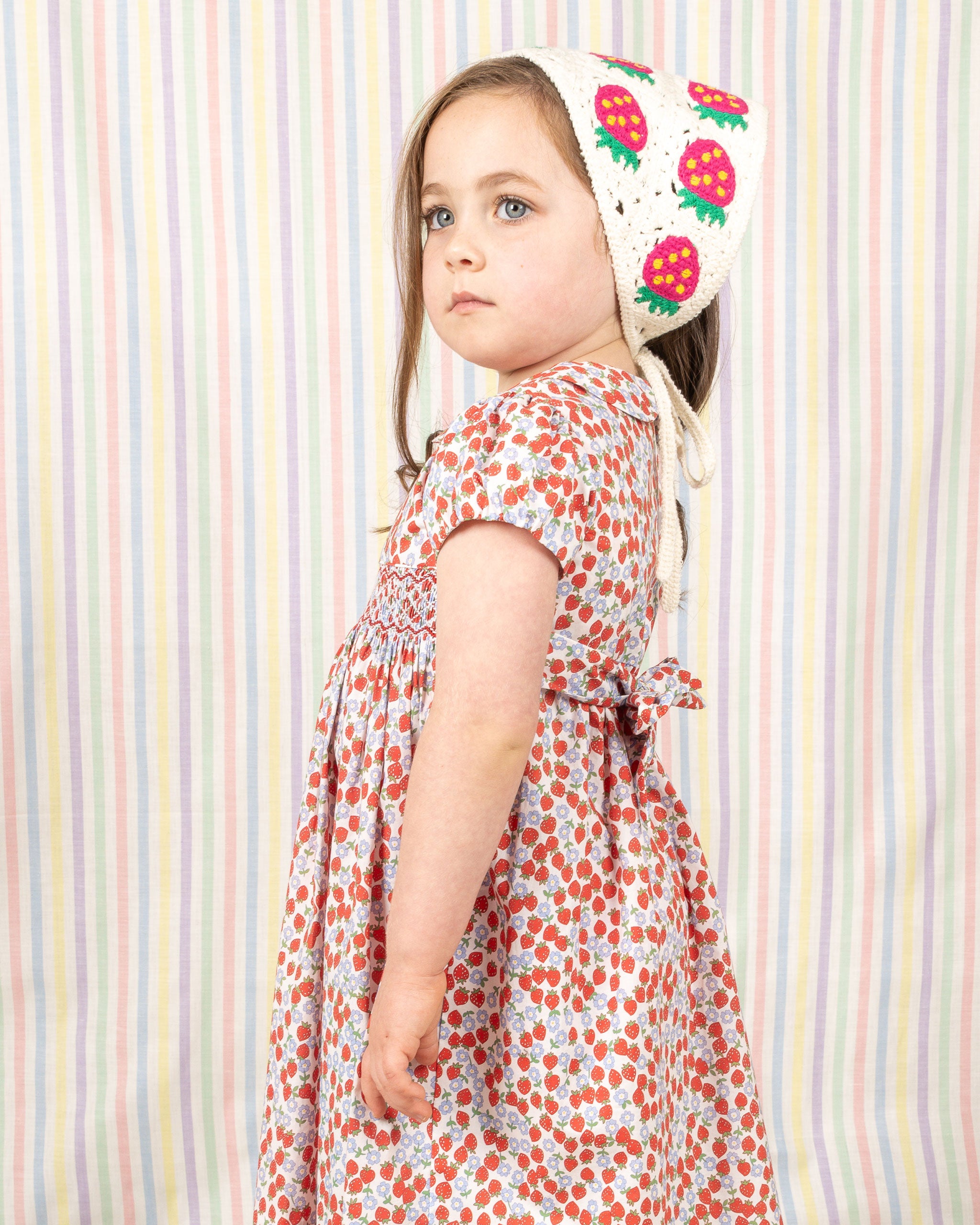child model in smocked dress made from strawberry print fabric