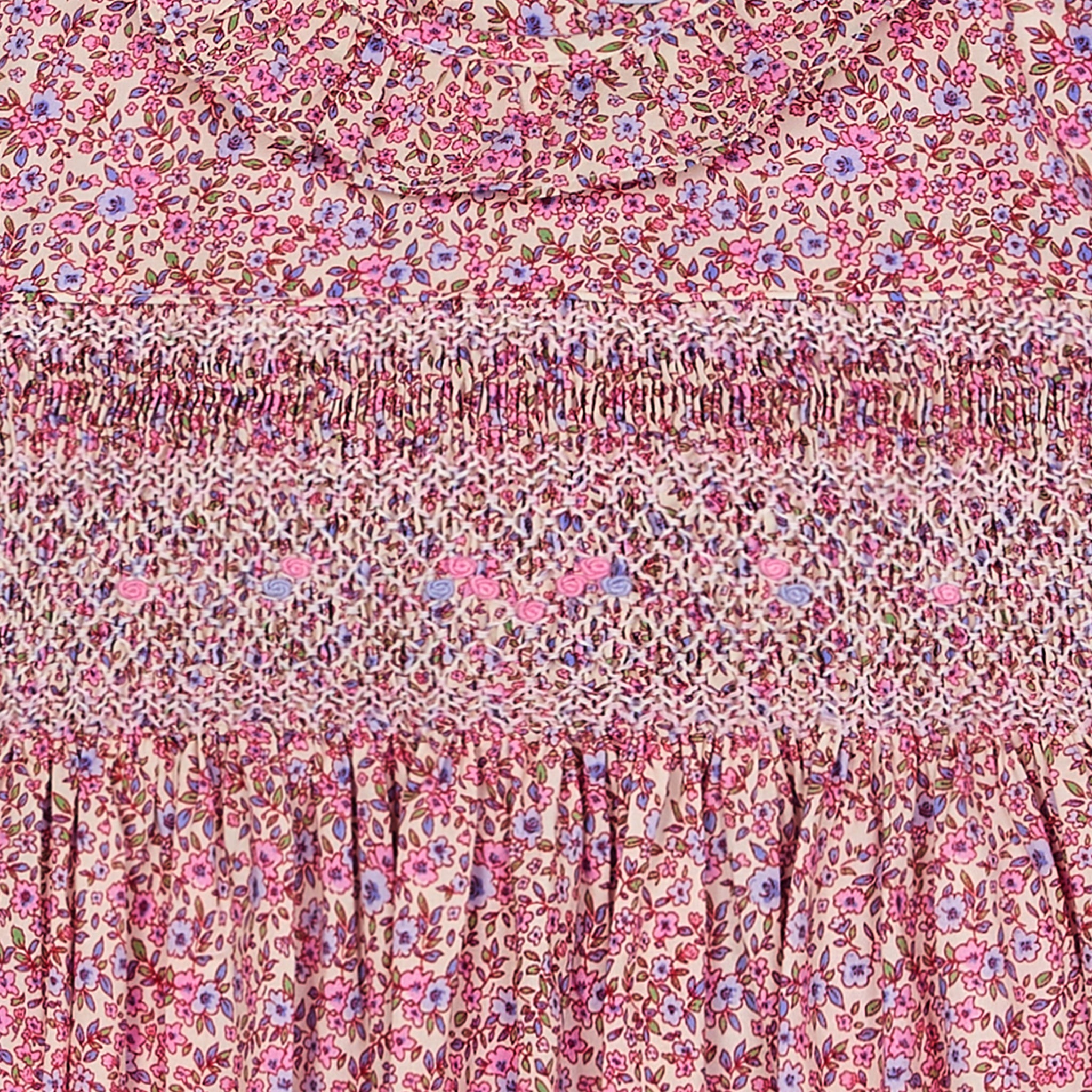 Floral patterned fabric and hand smocking closeup