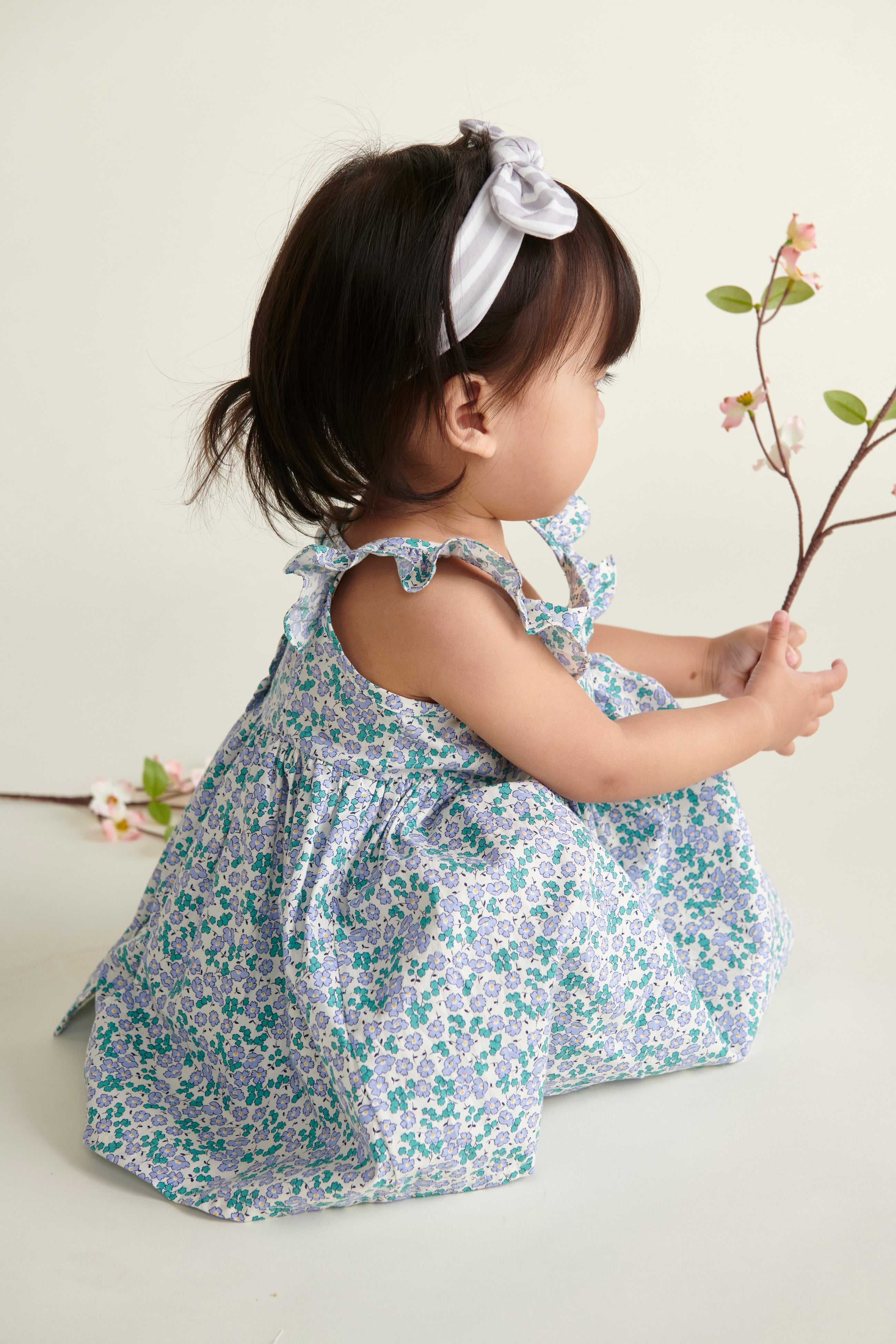 baby in lilac floral dress