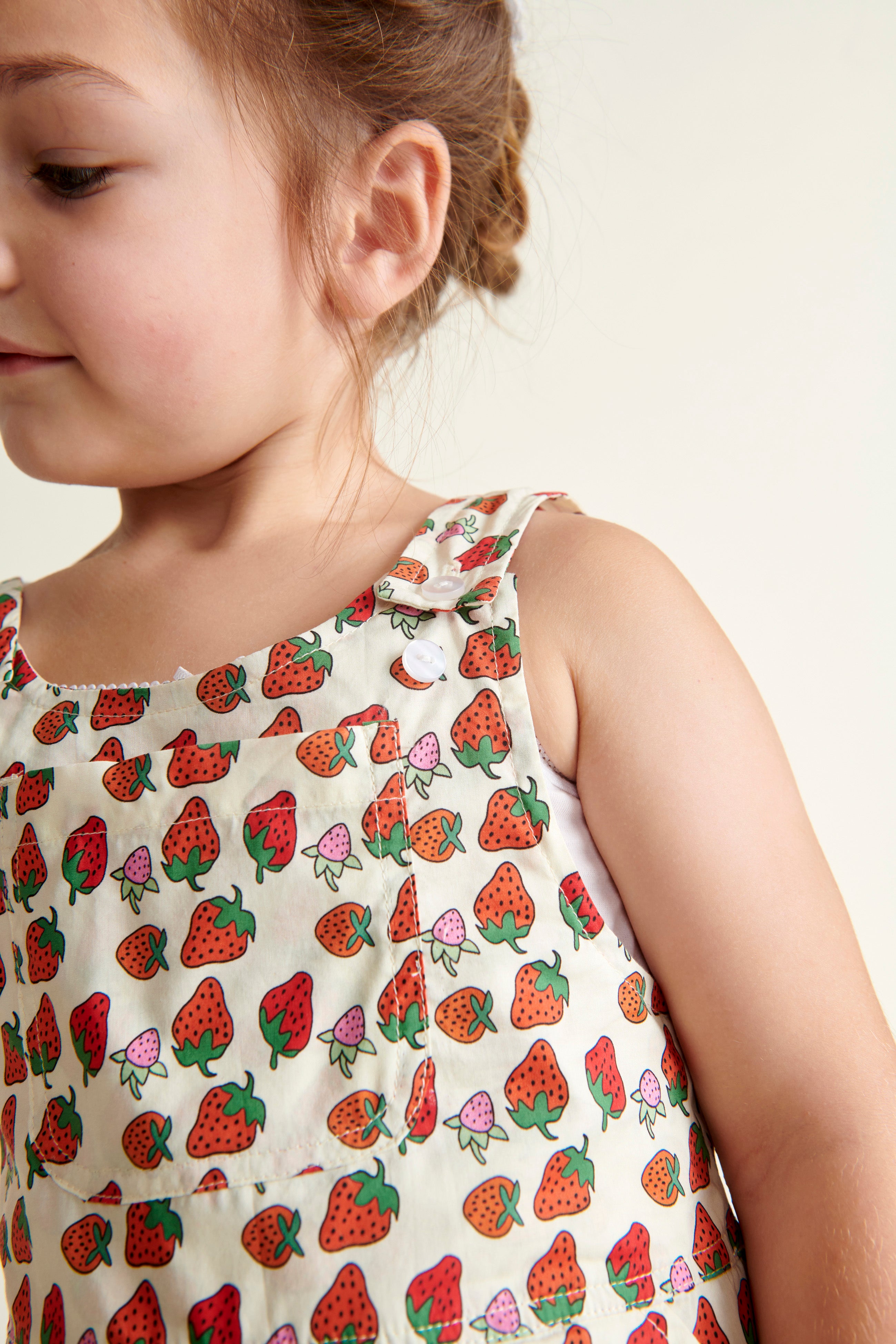 strawberry dungarees closeup