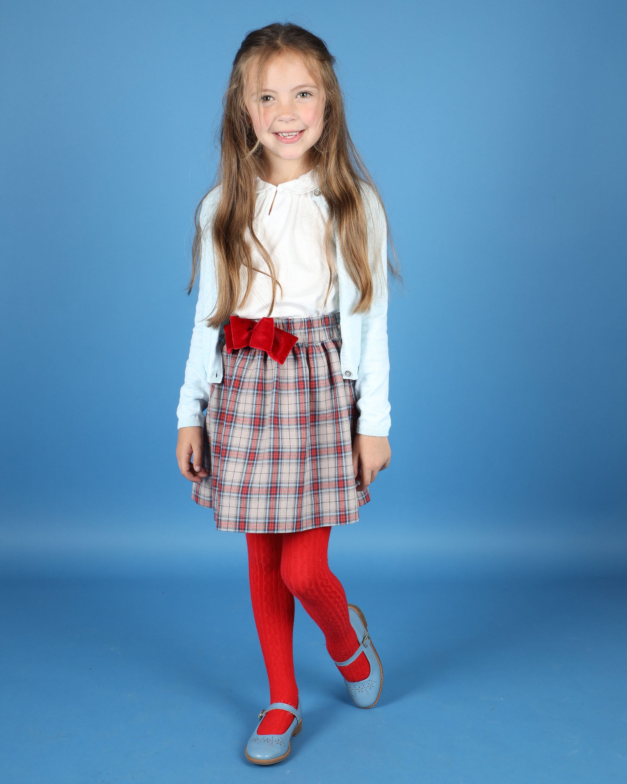 girl in tartan skirt with bow