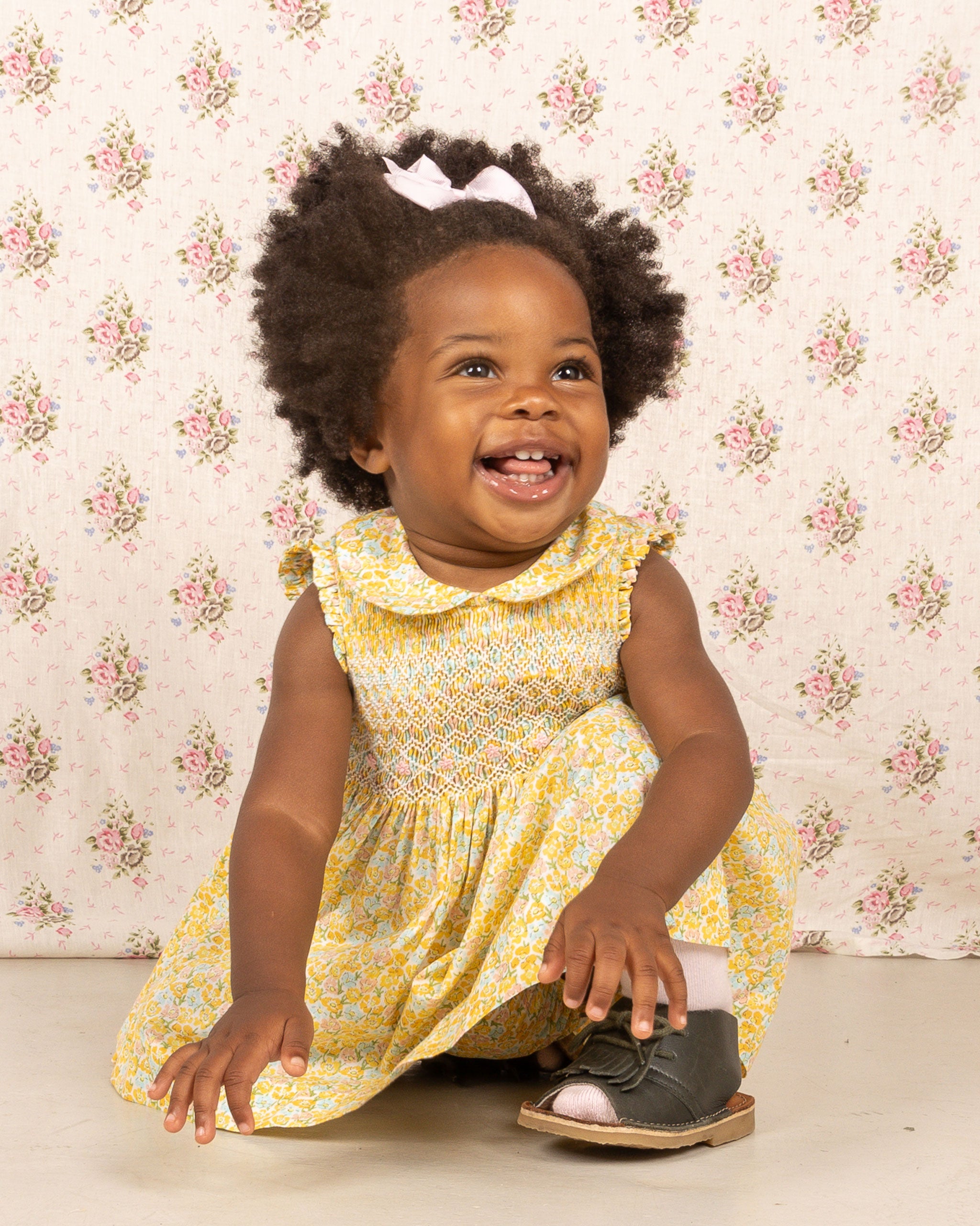 baby in yellow hand-smocked dress