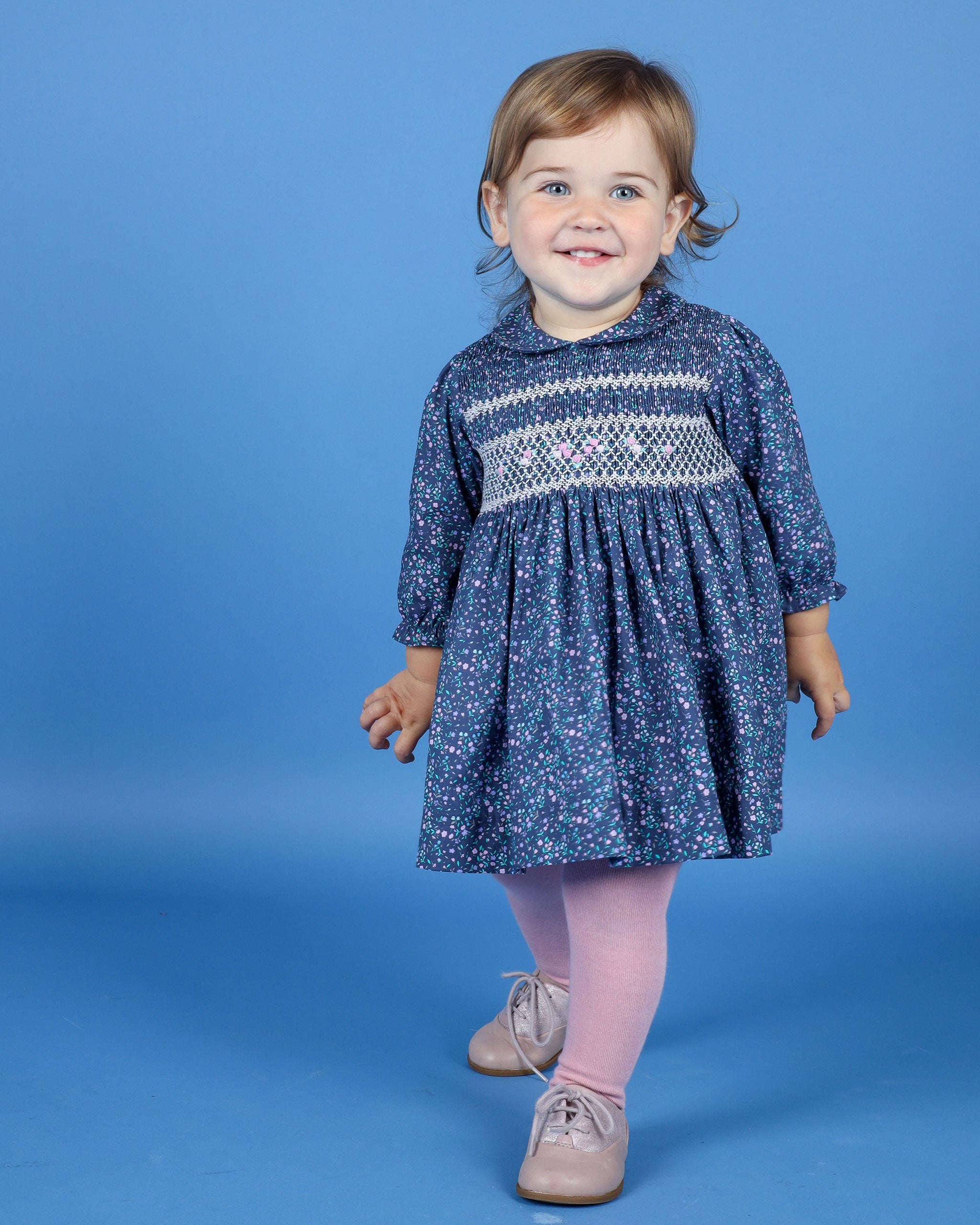 toddler girl in bay smock dress