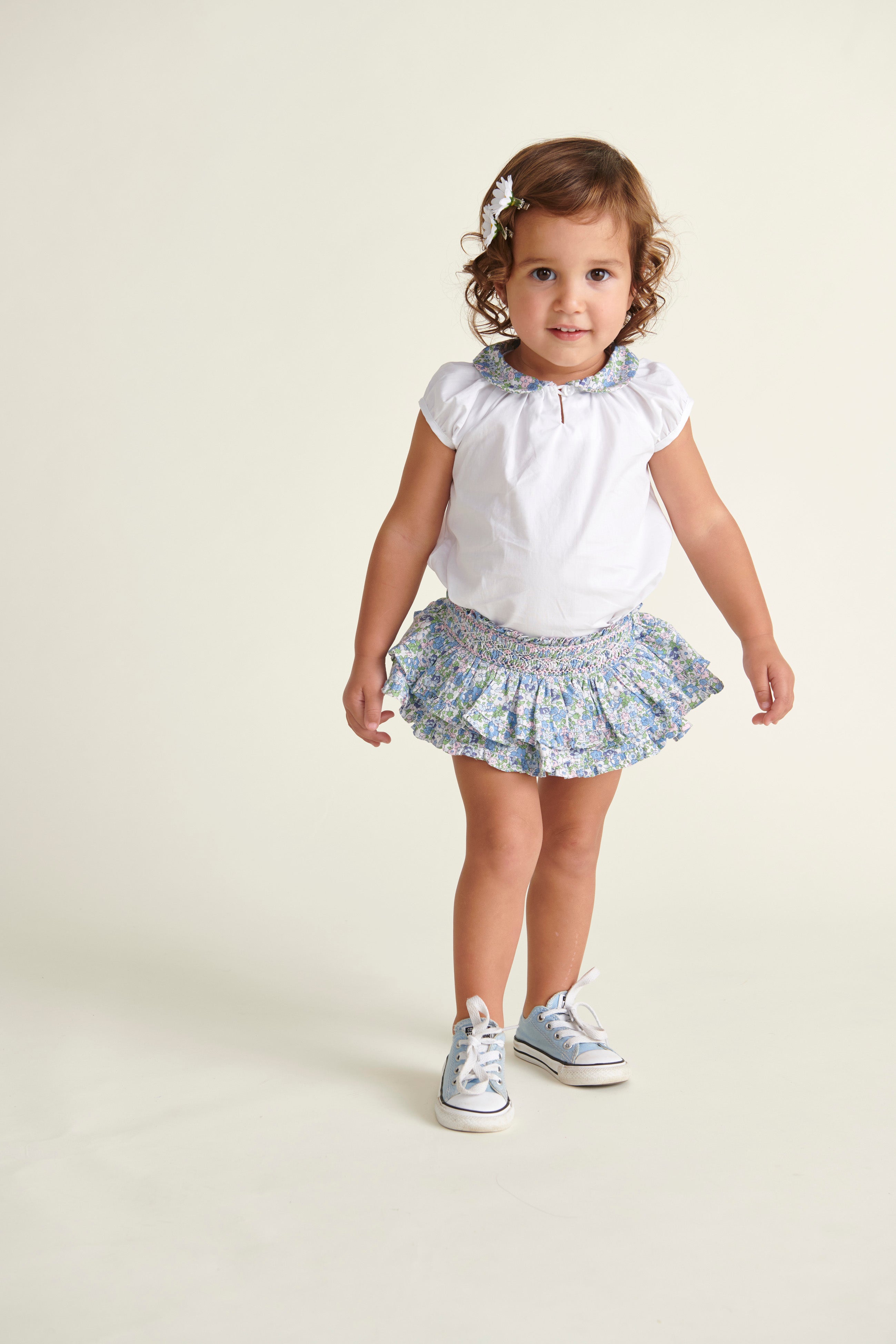 toddler in matching skirt and blouse set
