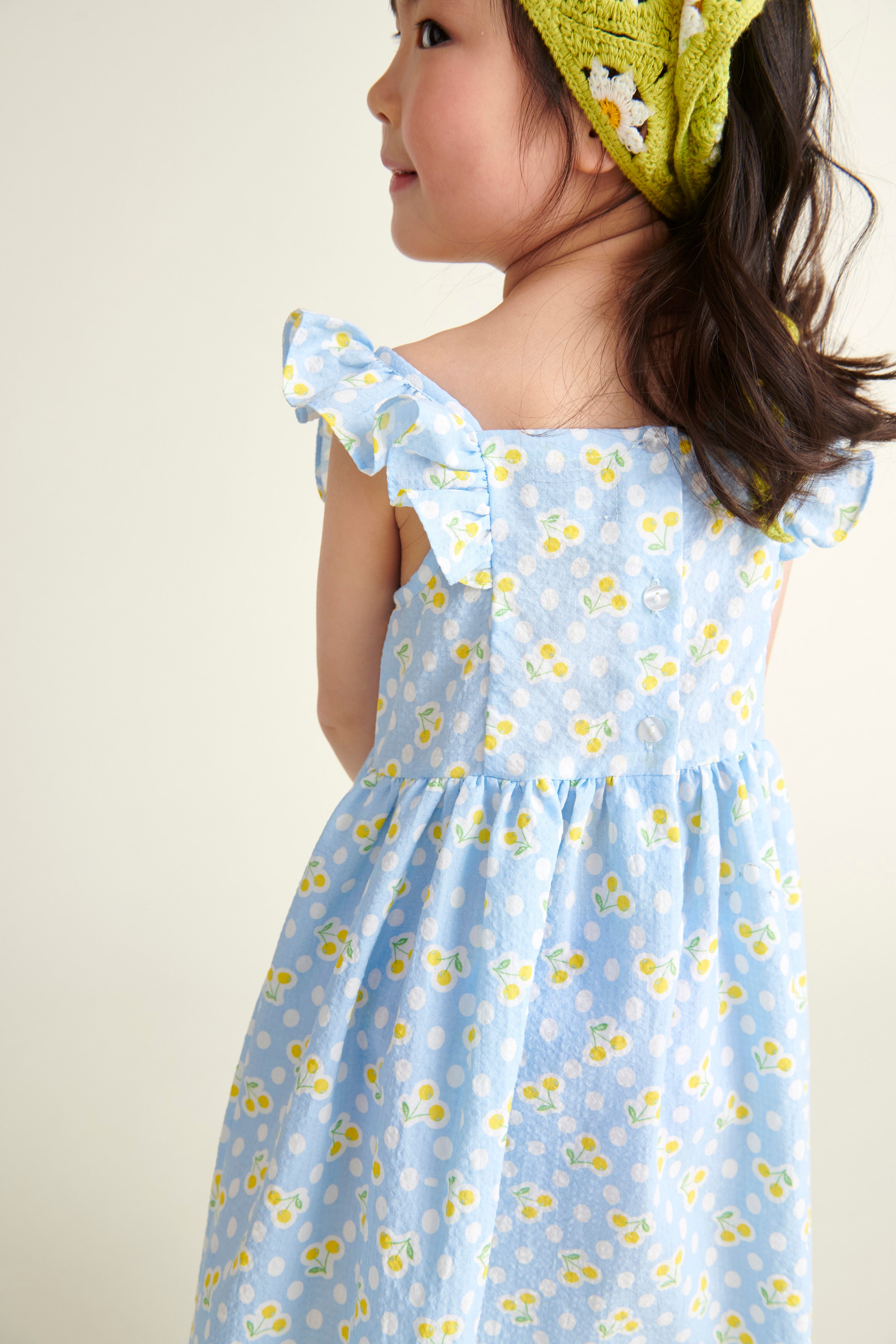 girl wearing baby blue sundress from behind