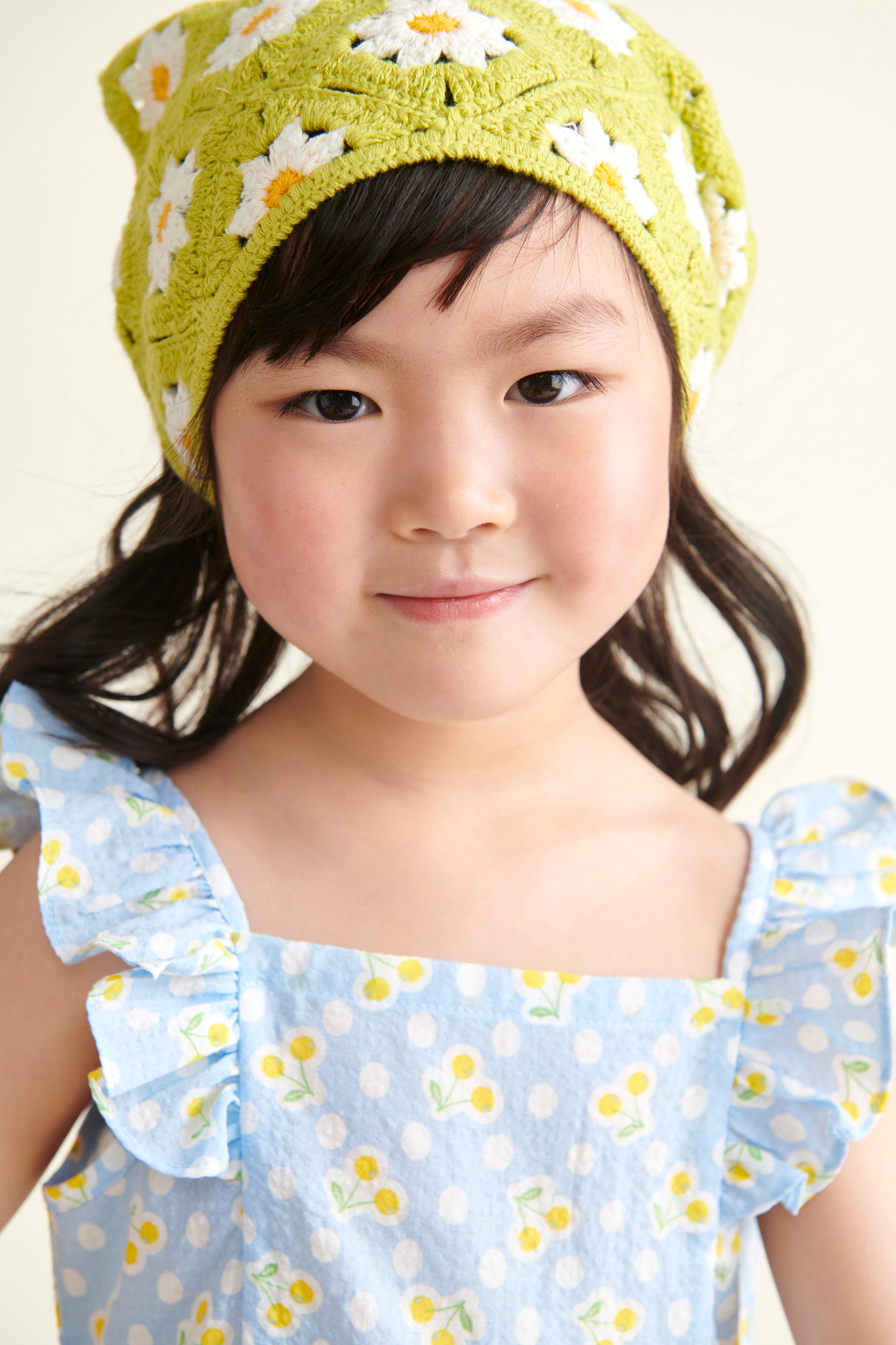closeup of girl model in blue sundress with yellow cherry print