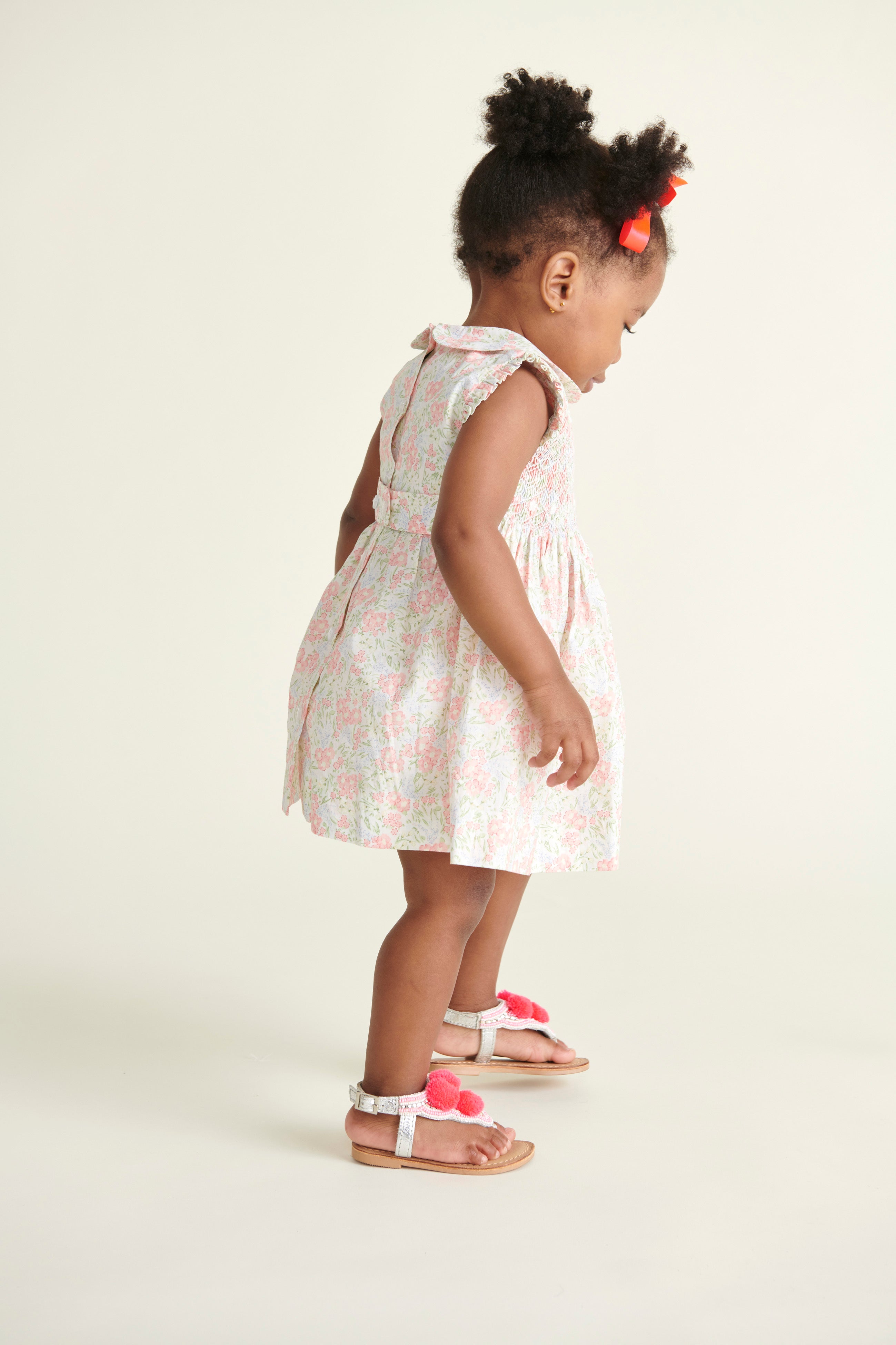 toddler wearing smocked dress, back