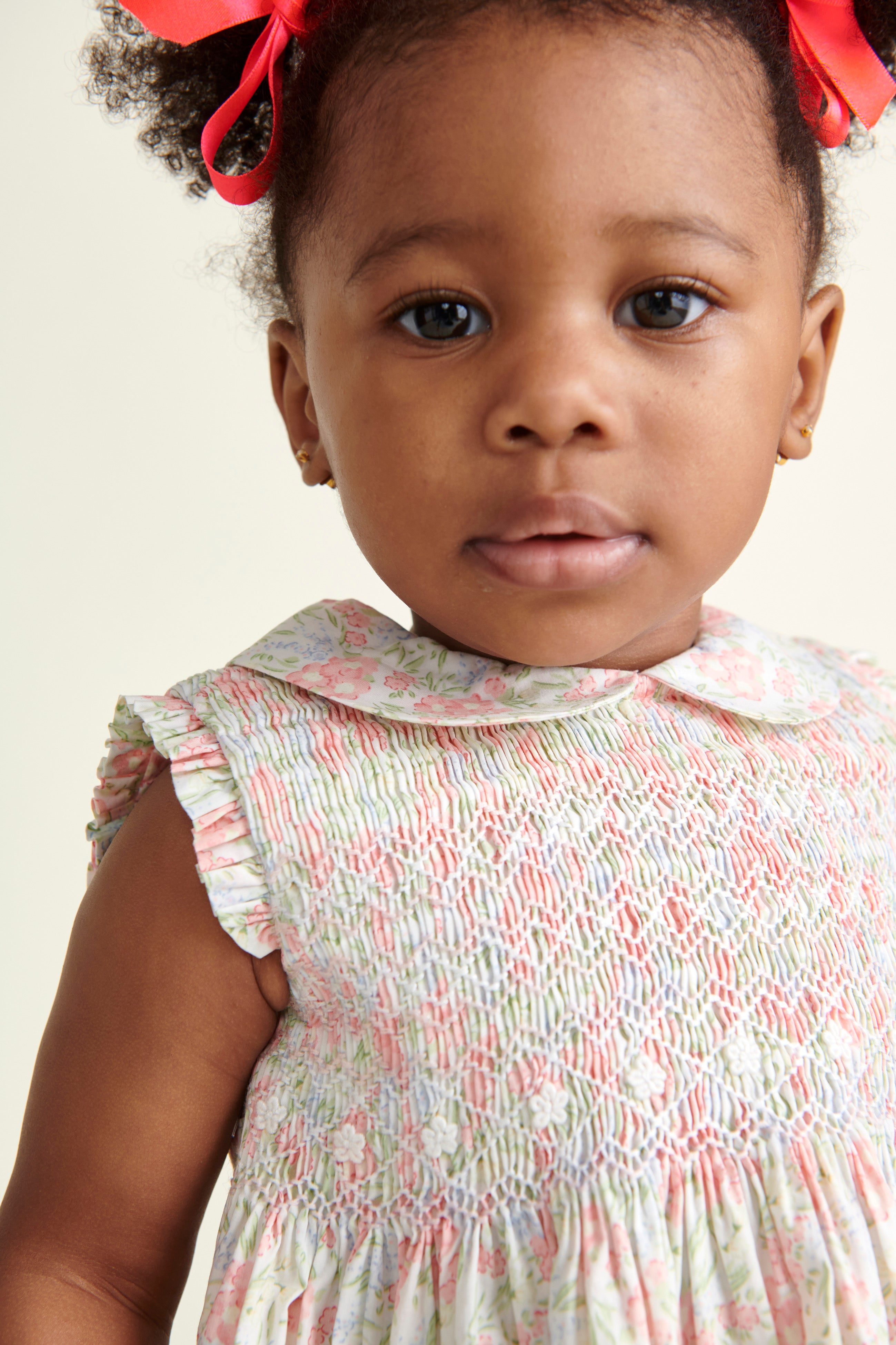 pink pastel hand-smocked dress worn by toddler