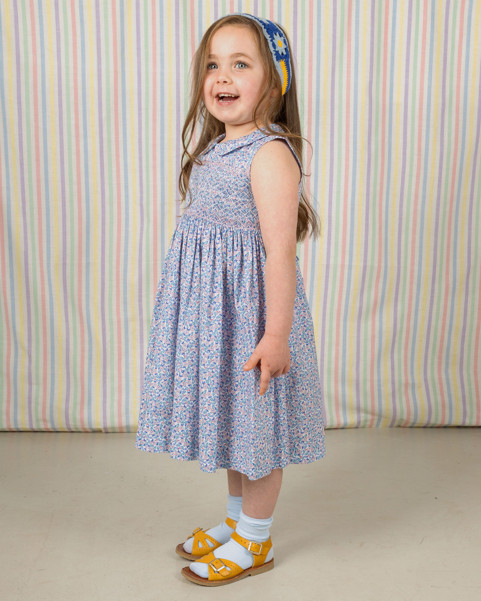 girl in ditsy floral smock dress