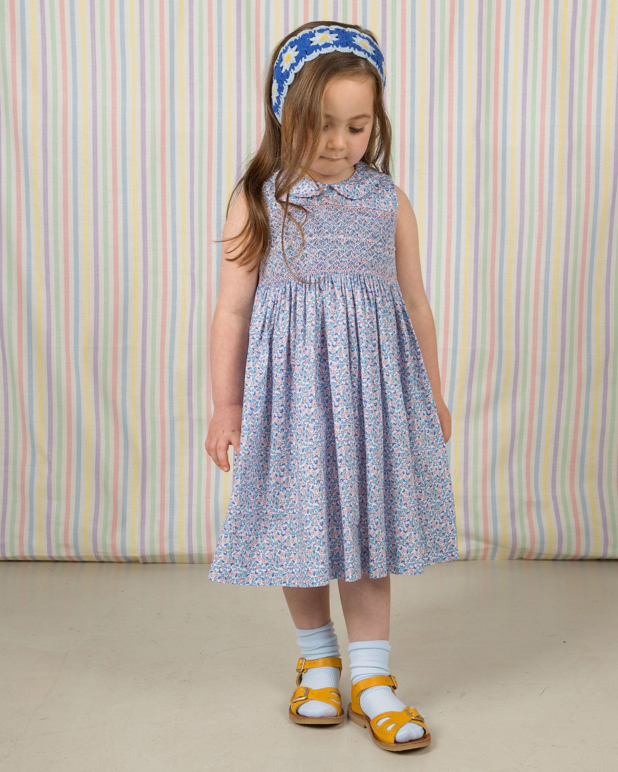 girl wearing smocked dress, floral design