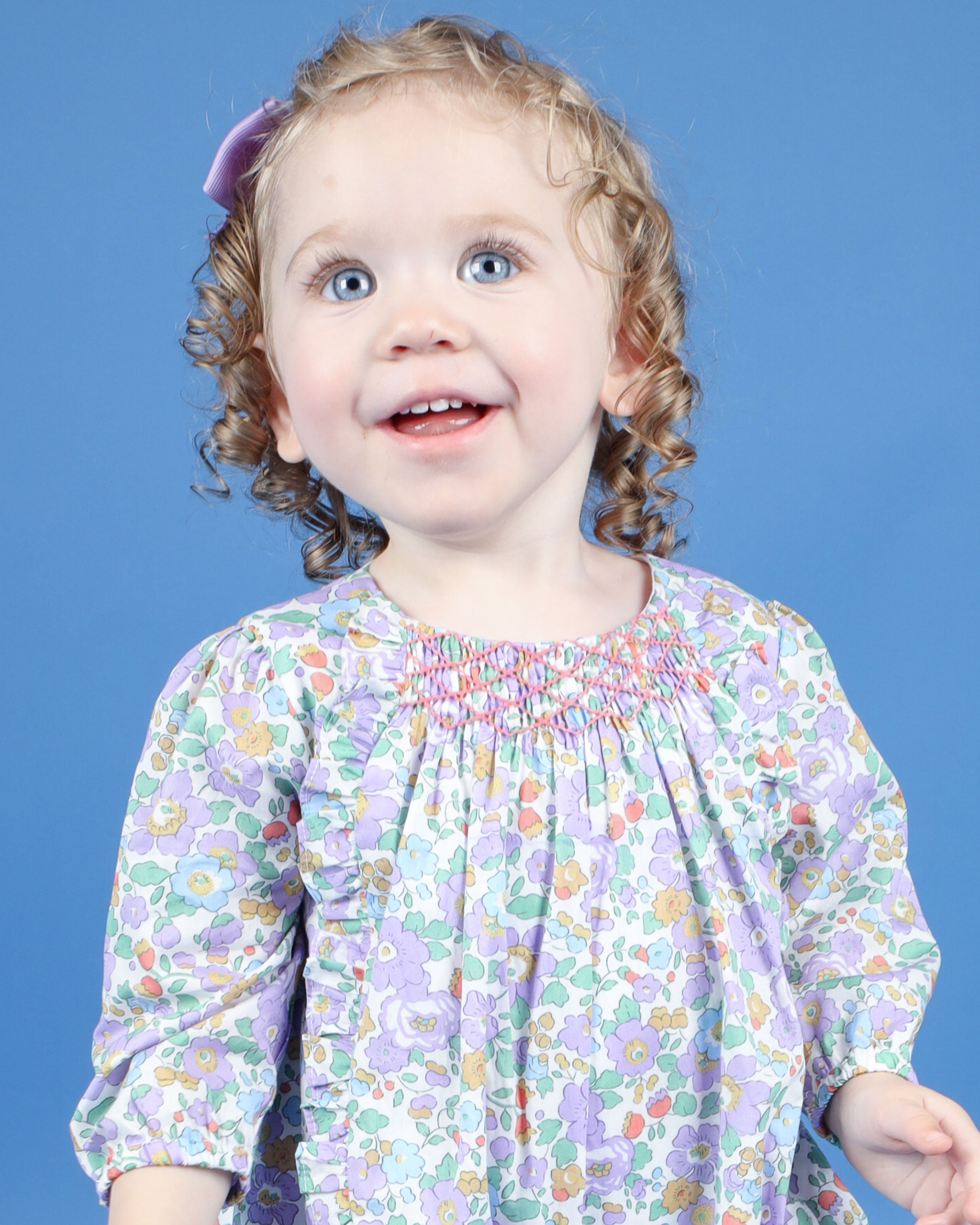 closeup of baby in purple floral bubble