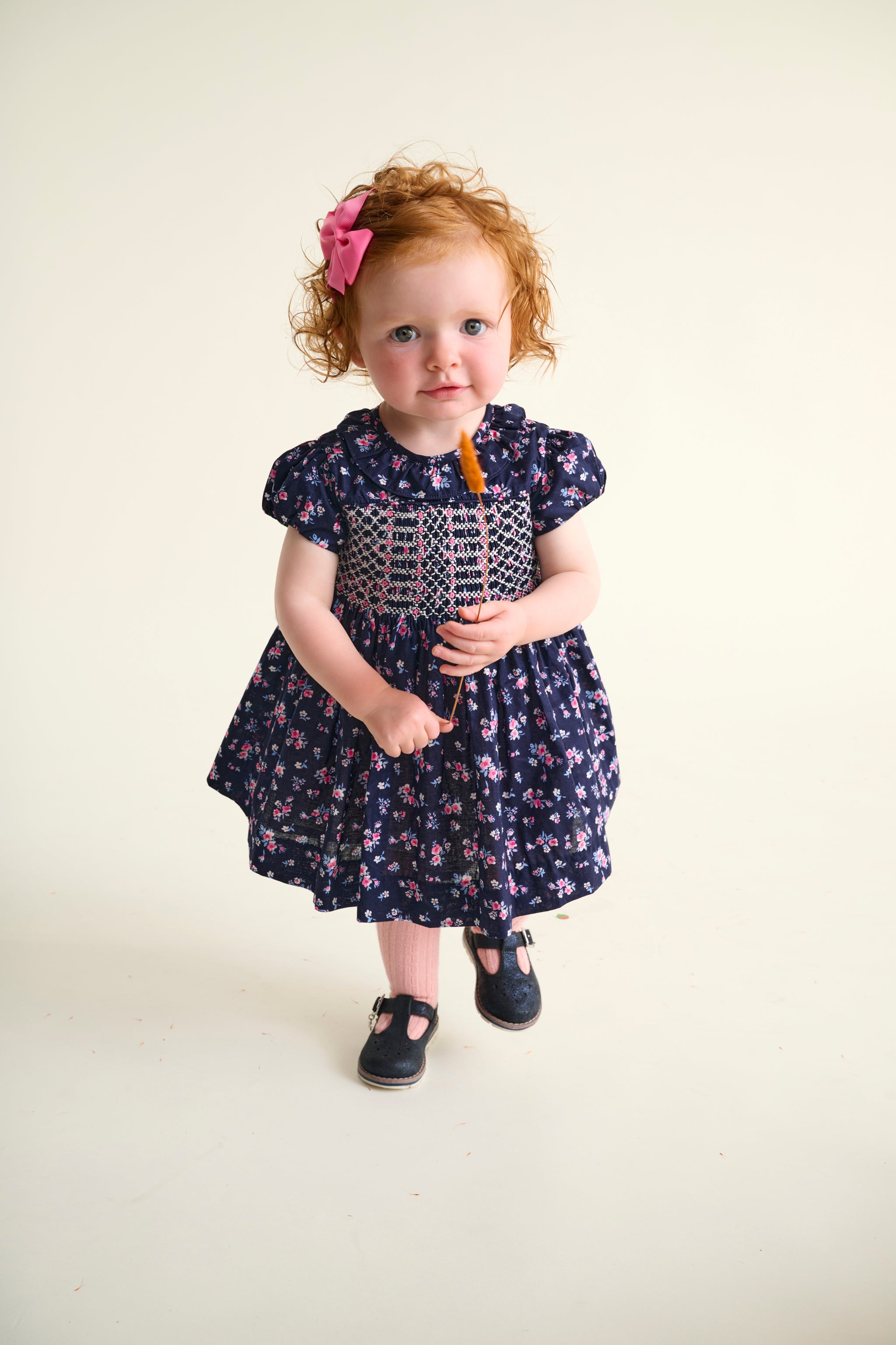 baby girl in navy floral smocked dress