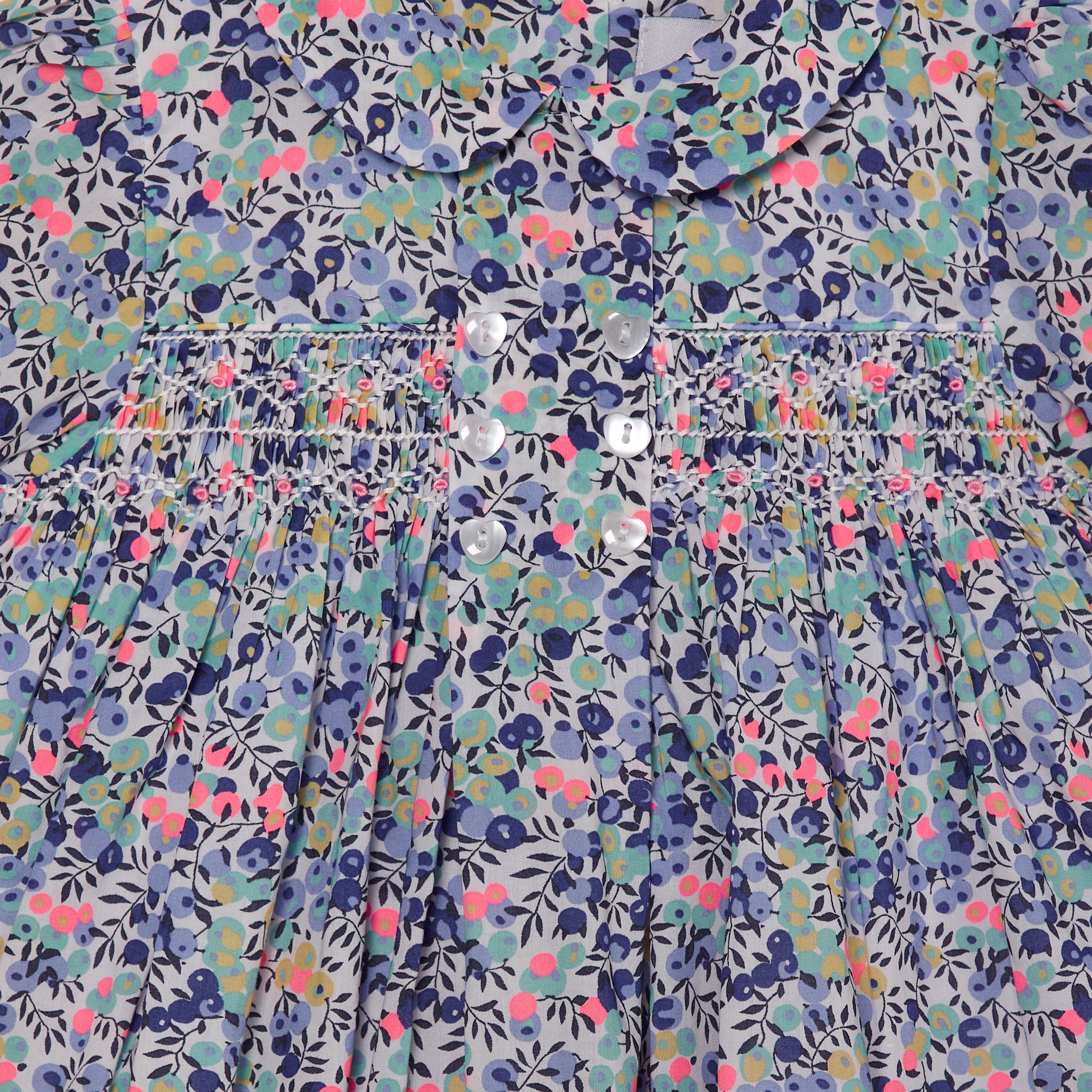smocked baby dress made from Liberty fabric, berry print, smocking closeup