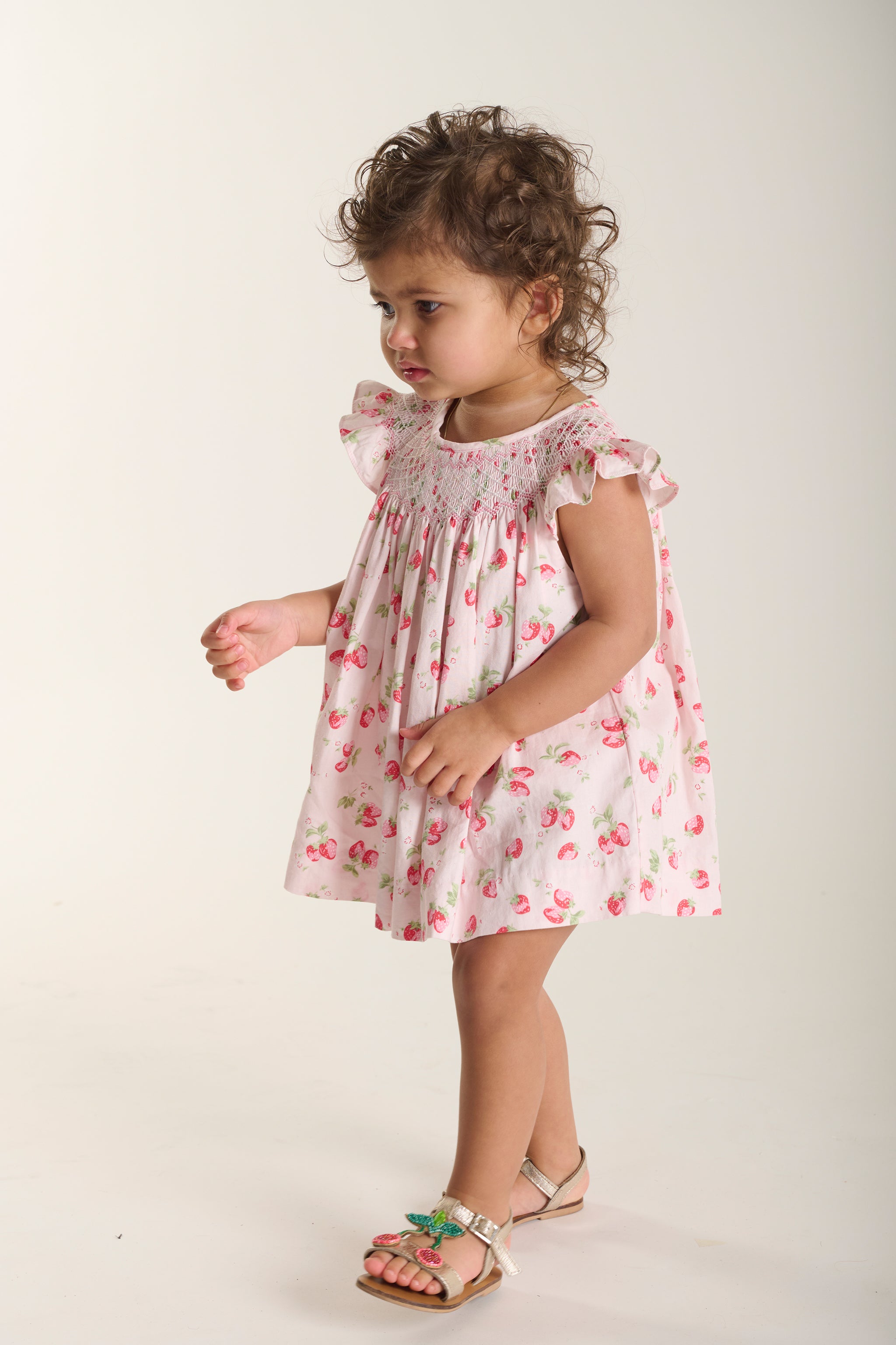 toddler in strawberry dress