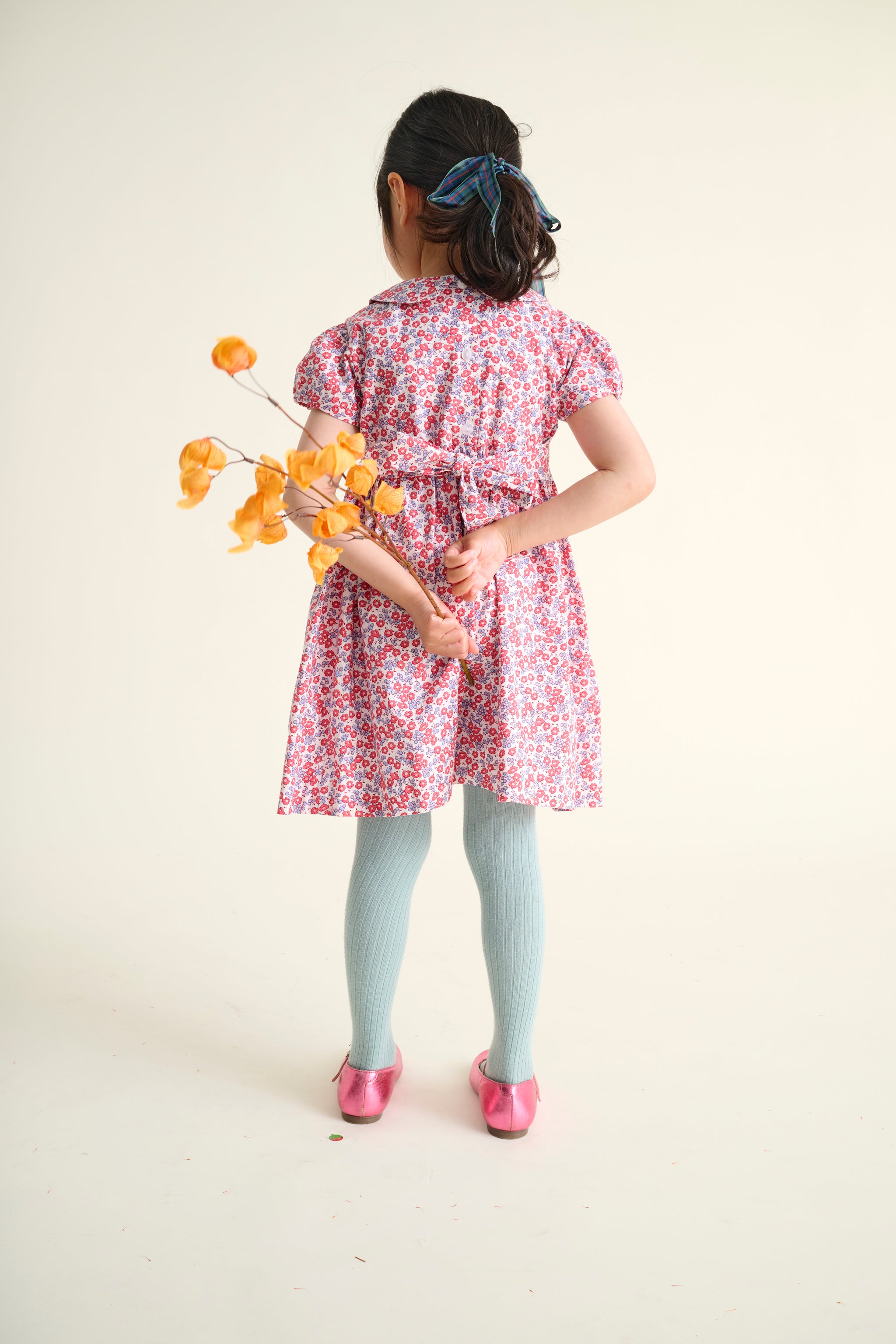 Young girl in a floral dress back view