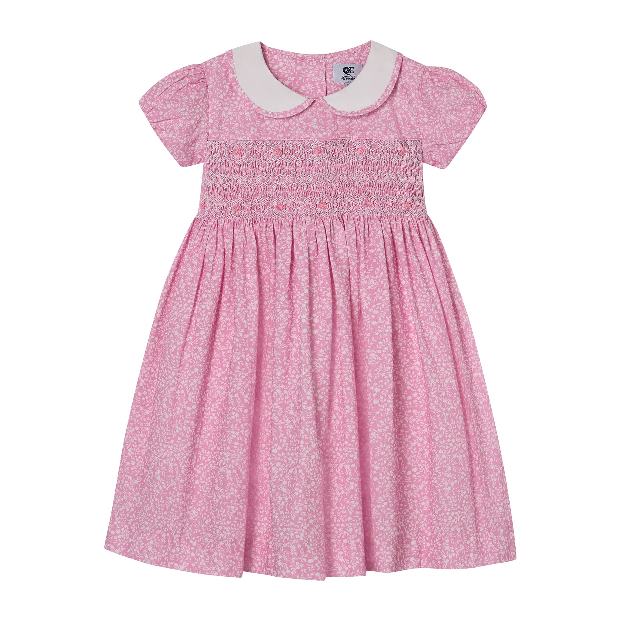 Pink floral dress with a white collar and intricate hand smocking