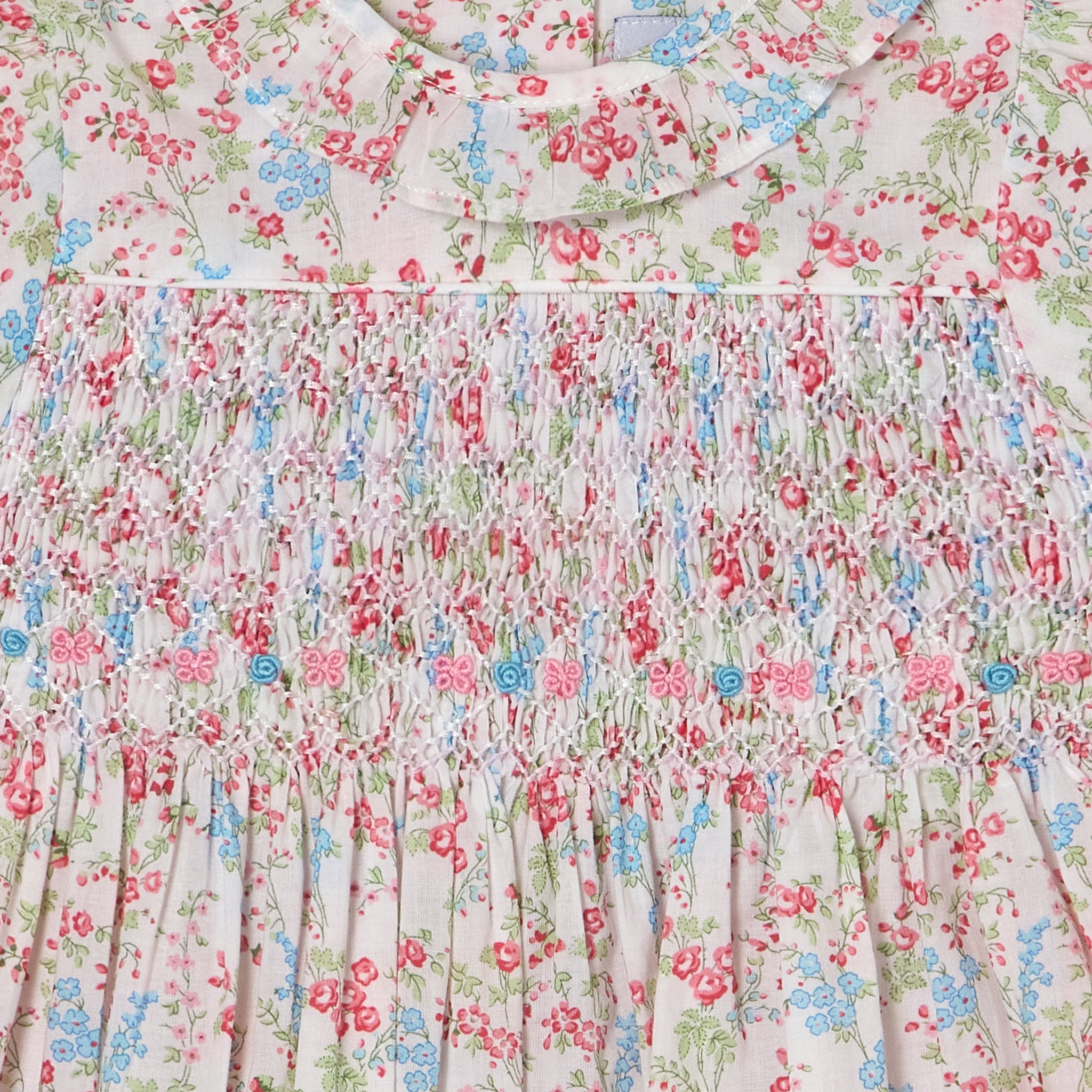 Floral patterned dress with ruffled collar and hand-smocking