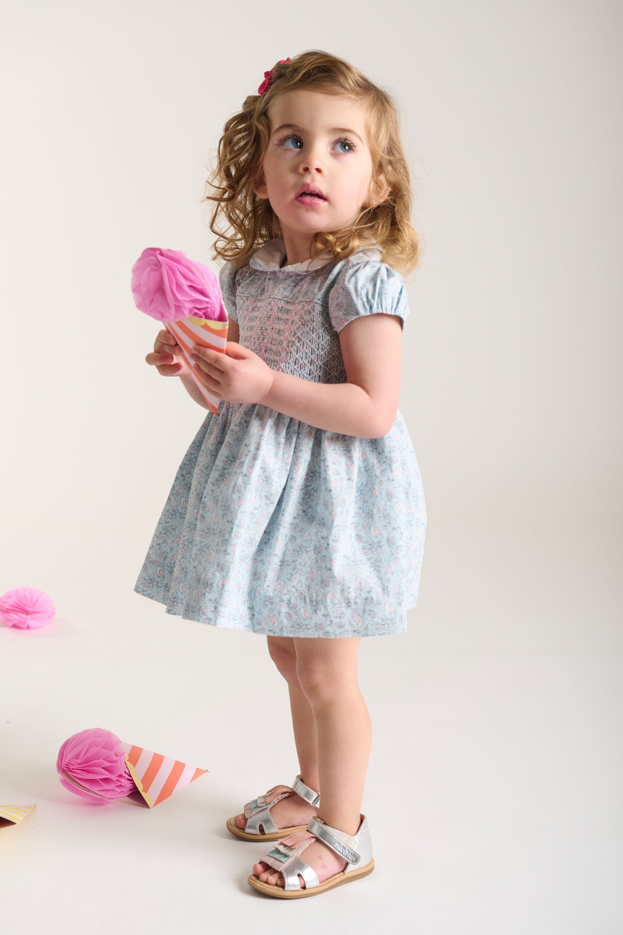 toddler girl in pale blue smock dress aderyn
