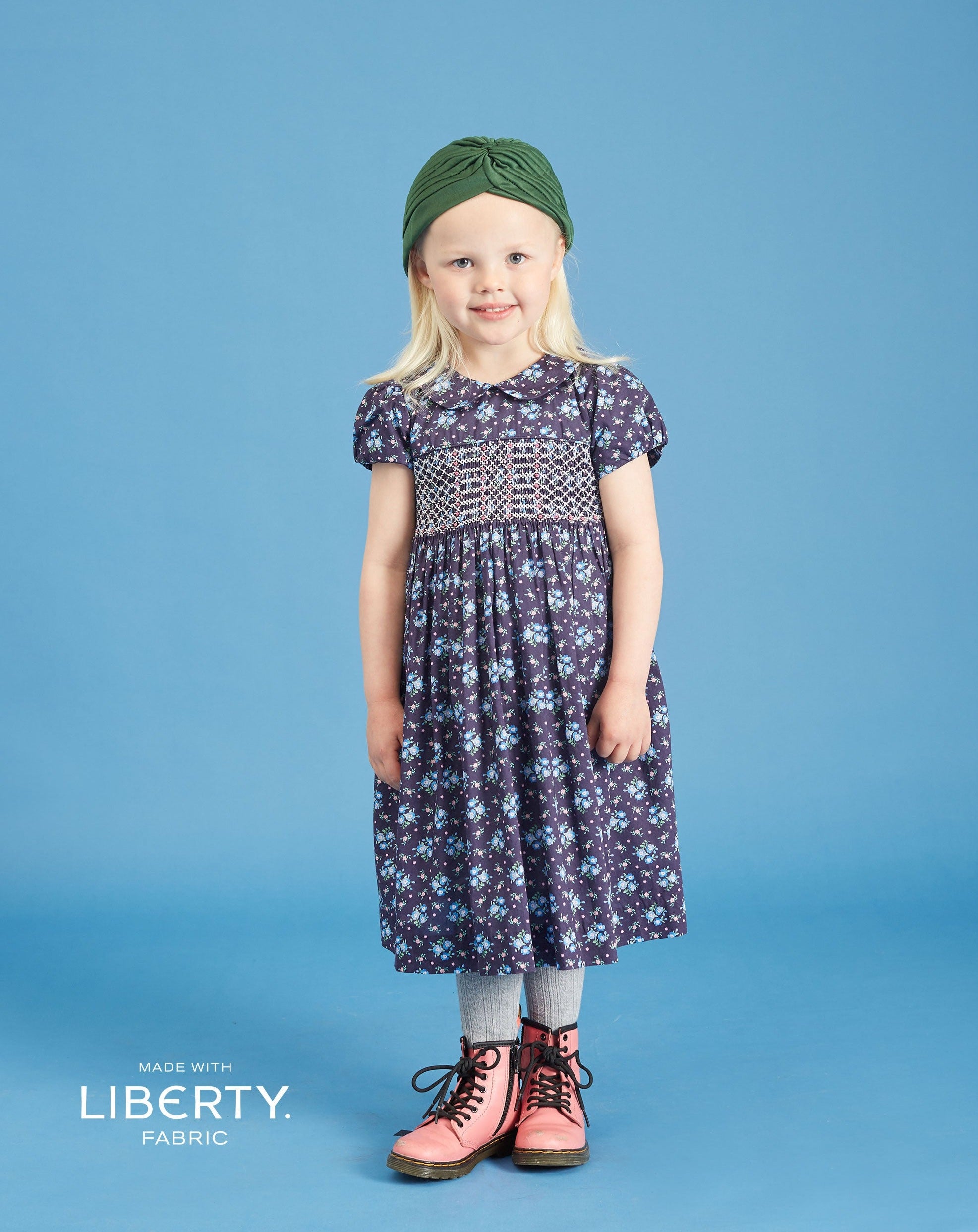 girl in navy smock dress