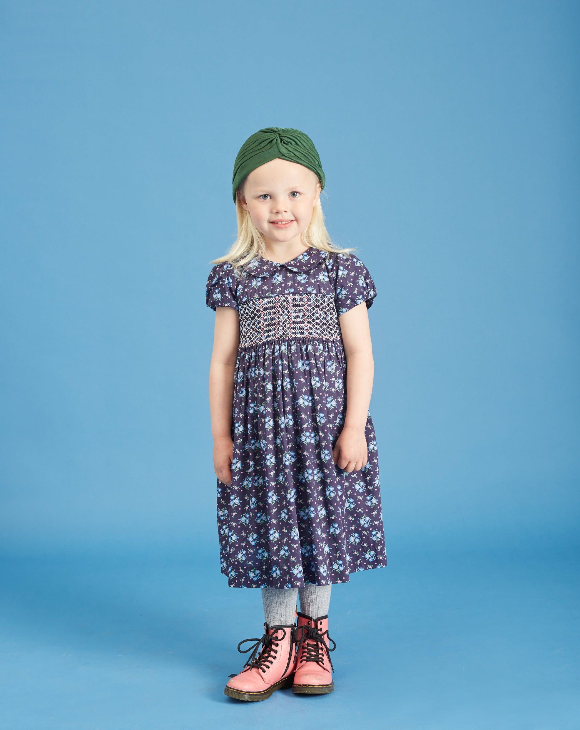 girl wearing hand-smocked Liberty print dress