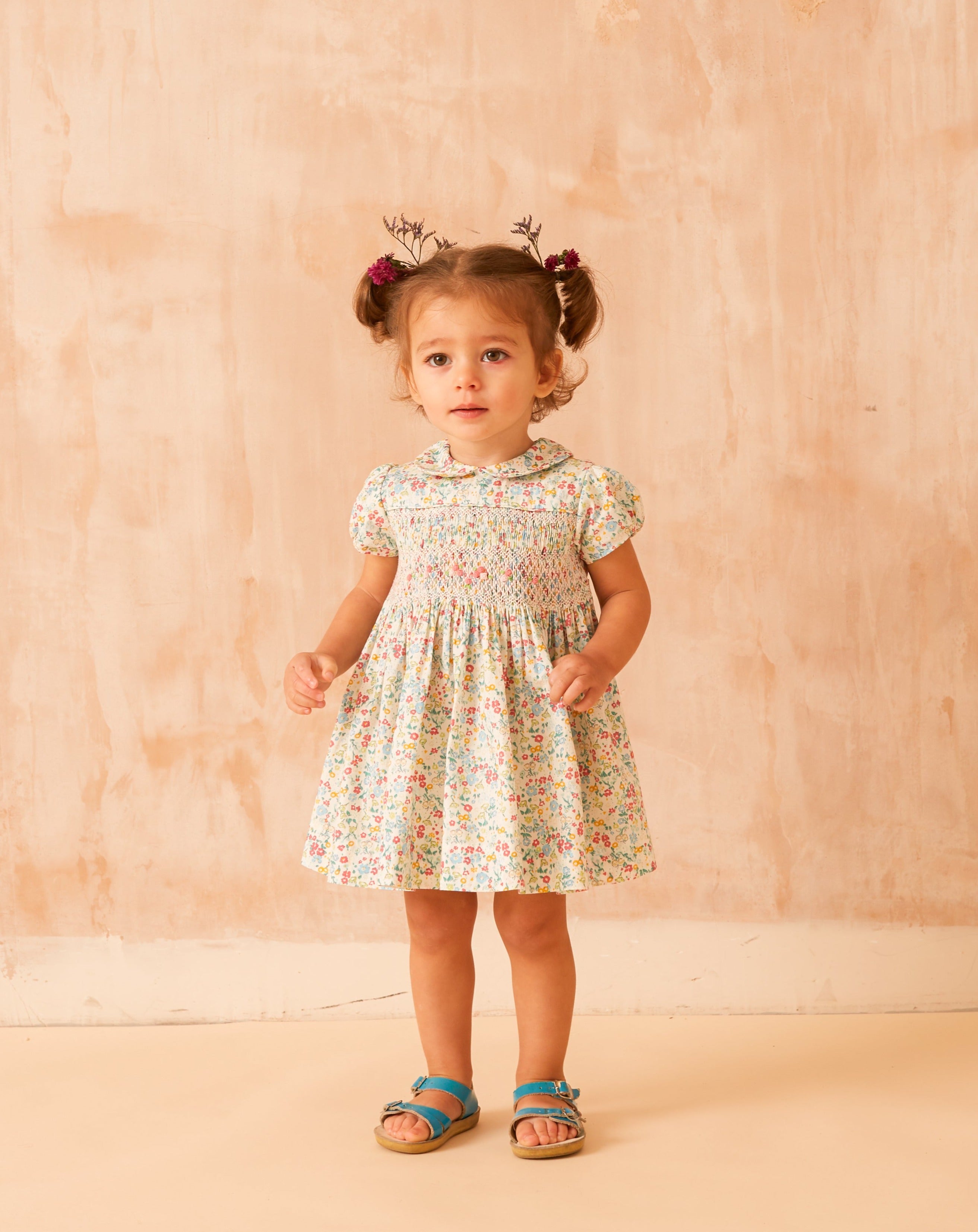 baby wearing smocked summer dress