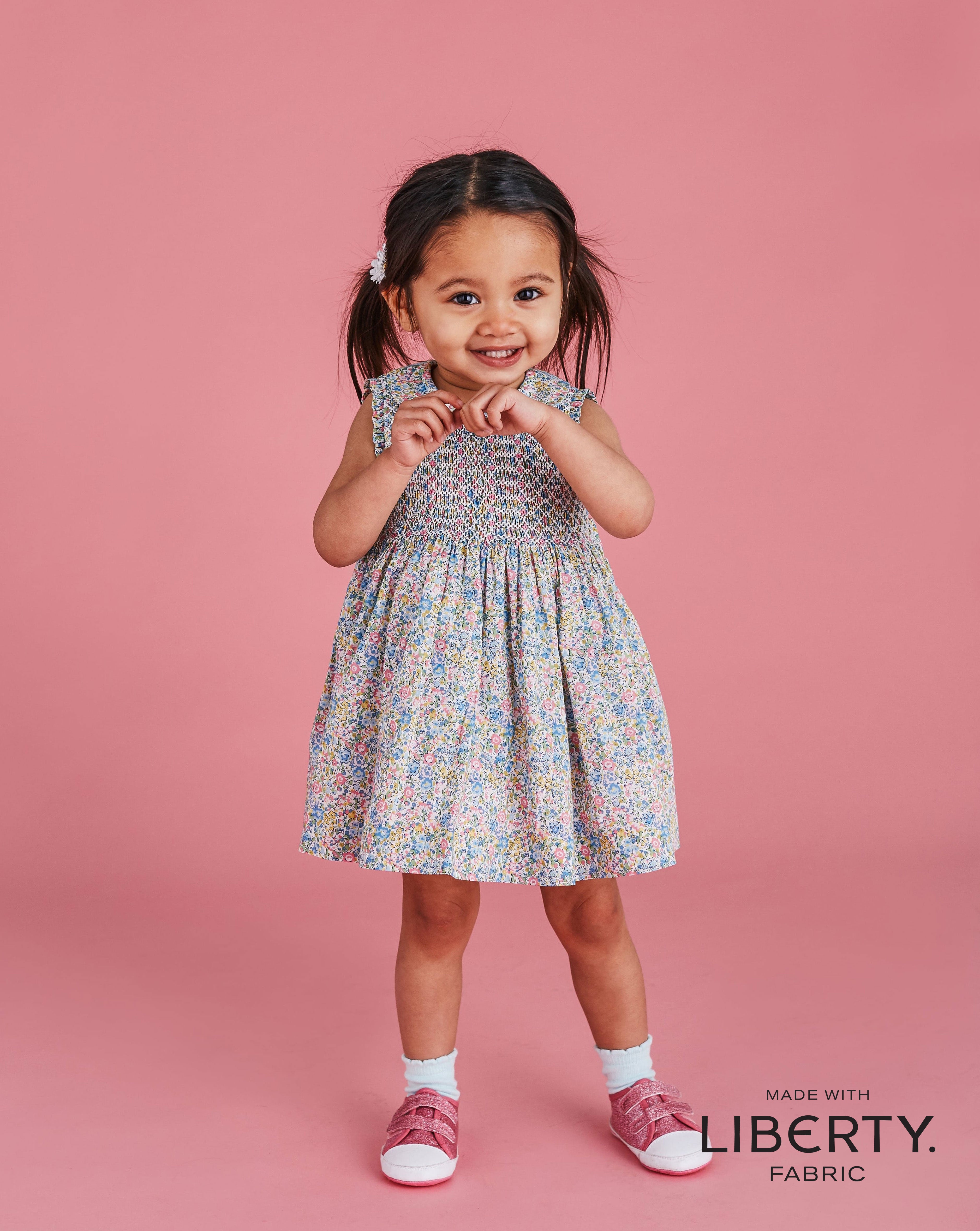 floral Liberty fabric dress for baby worn by girl