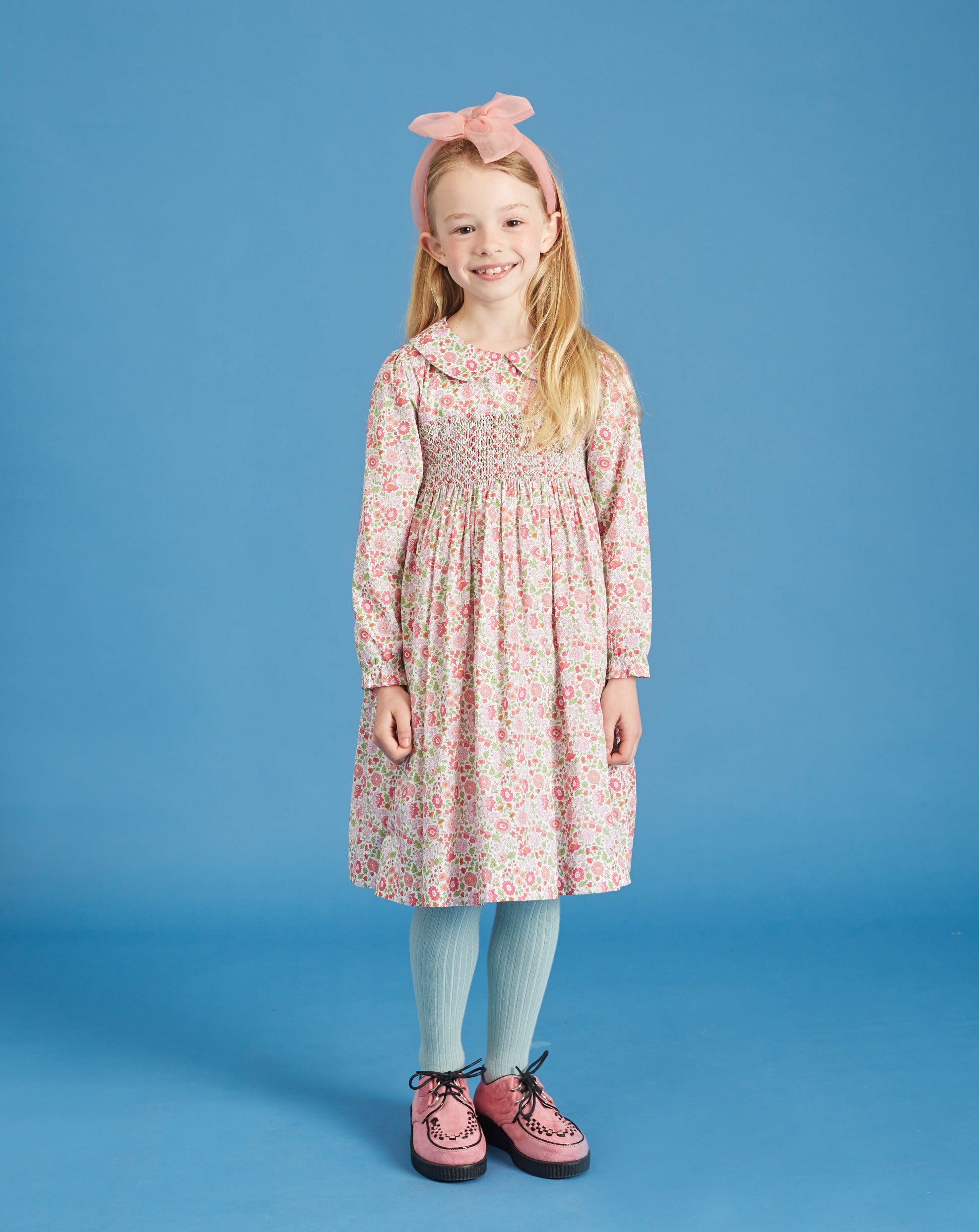 girl wearing hand-smocked dress made from Liberty fabric