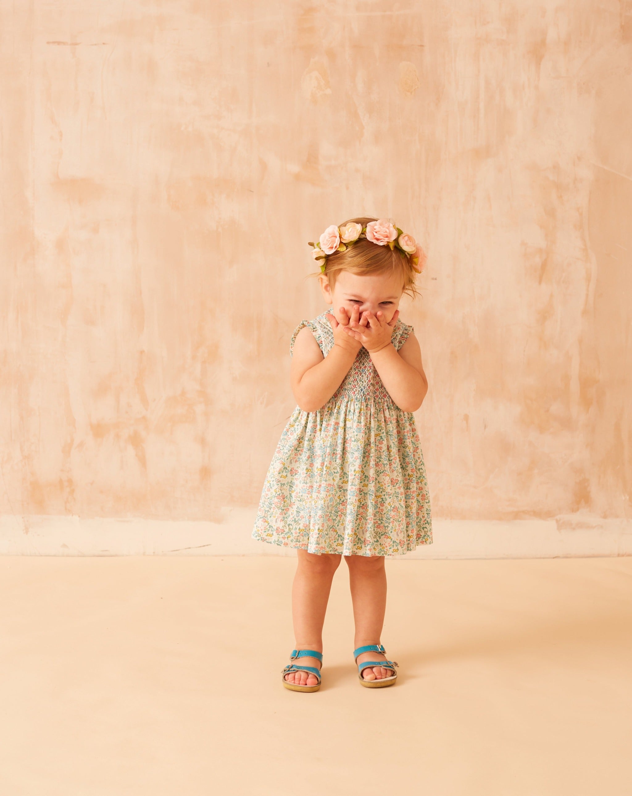 baby in floral smock dress